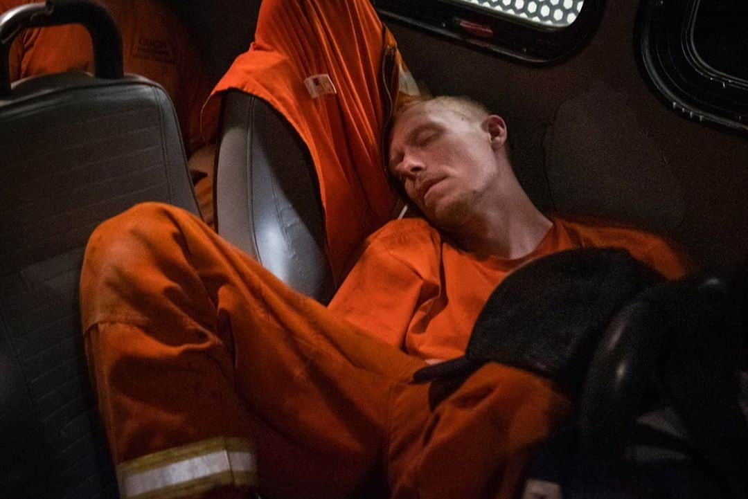 TIME Magazineさんのインスタグラム写真 - (TIME MagazineInstagram)「On Sept. 8, photographer Ethan Swope was driving down Lumpkin Rd. in Oroville, Calif., when he reached @calfire Feather Falls Station #51. Engines were arriving to protect the station and nearby homes from a rapidly approaching fire, including the Sugar Pine Conservation Camp inmate crew. "At a certain point, I realized it would no longer be safe to stay and I backed off from the front. The next morning, I returned and found the crew resting. They were welcoming, despite having been up for 24 hours, and said at one point they were surrounded by fire. 'We almost died,' one admitted." Inside the dark interior of the engine, Swope photographed an inmate firefighter catching up on sleep. Several of the men spoke of being interested in eventually pursuing a career in firefighting. Days later, California Gov. Gavin Newsom signed AB 2147, creating an easier path for inmate firefighters to become professional ones after they are released. Photograph by @ethanswopephoto」9月15日 8時13分 - time