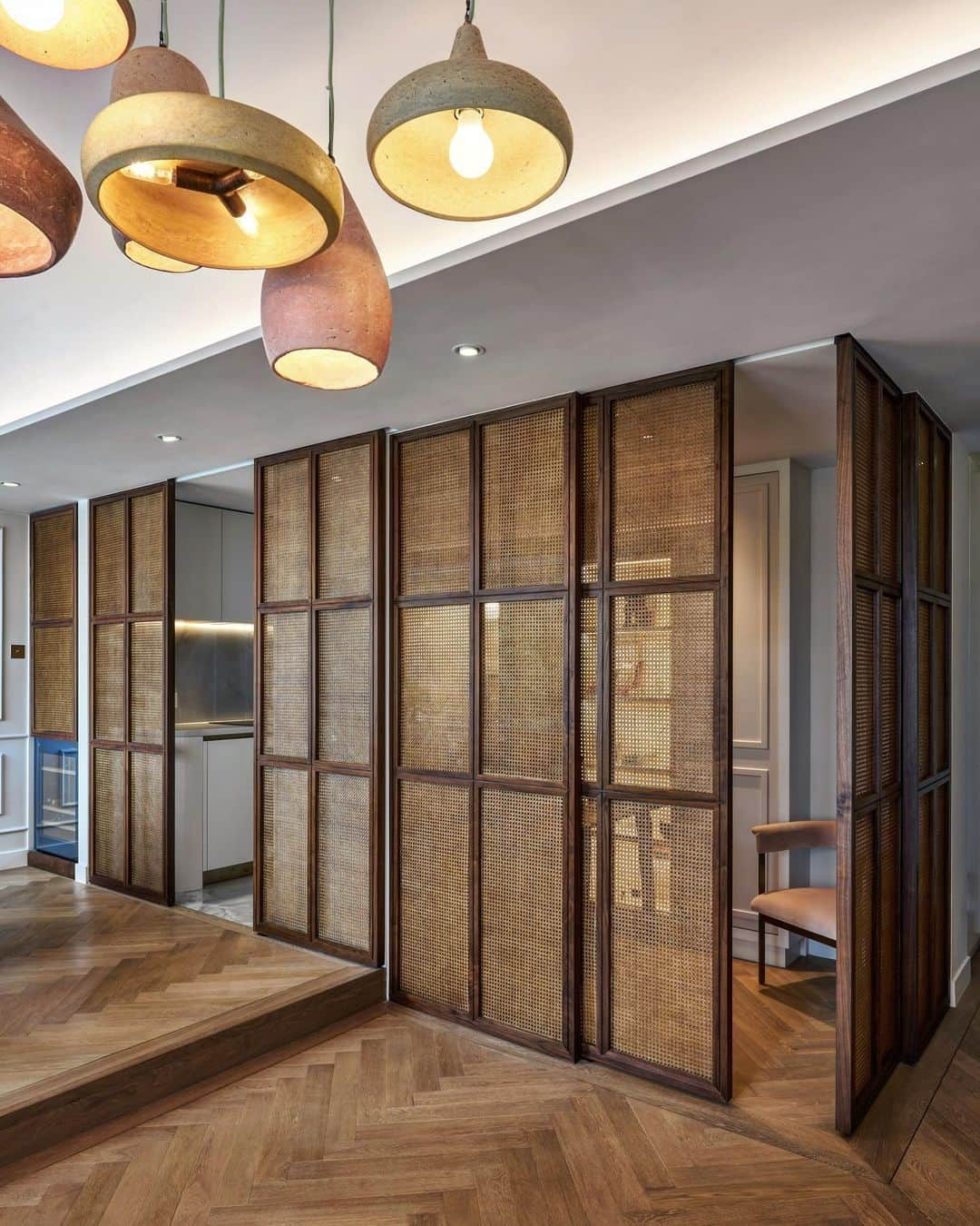 JJ.Acunaのインスタグラム：「A shot of a beautiful feature sliding panel system of Walnut and Rattan separating the Great Room from the Bureau and Kitchen Area with handcrafted clay pendants from Austin, Texas sourced by my Client for their Mid-Levels home. Completed Summer 2020. @jja.bespoke.studio . . . #residentialdesign #interiordesign #design #designinteriors #jjacunabespokestudio . . 📸: XU Liang Leon, aka @frontality___」