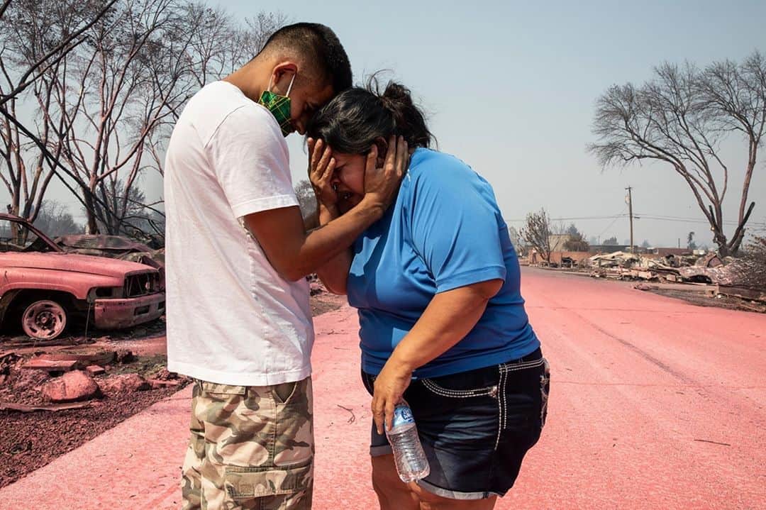 TIME Magazineさんのインスタグラム写真 - (TIME MagazineInstagram)「Dora Negrete is consoled by her son, Hector Rocha, after seeing their destroyed mobile home at the Talent Mobile Estates in Talent, southern Ore., on Sept. 10 after wildfires devastated the area. "The entire park was completely gone," photographer Paula Bronstein recalls. Two families were there to see the ruins of their homes for the first time. "There's nothing left, there's nothing left," she heard Negrete say over and over. It was "a very tender moment," Bronstein says, "and very difficult at the same time because it was so emotional." Photograph by Paula Bronstein (@pbbphoto)—@apnews」9月15日 21時54分 - time