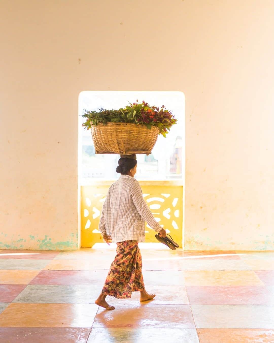 National Geographic Travelさんのインスタグラム写真 - (National Geographic TravelInstagram)「Photo by @emilypolar / A Burmese woman carries a woven basket of flowers to sell as offerings at the Golden Palace and Pagodas in Old Bagan, Myanmar. To see more of the magnificence in the mundane, follow me @emilypolar.」9月18日 1時06分 - natgeotravel