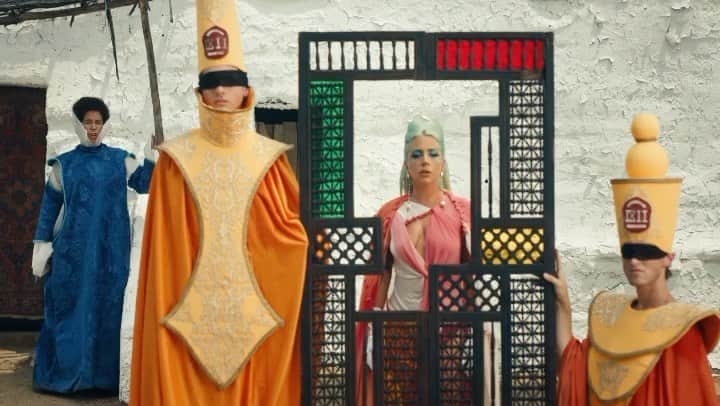 ニコラ・フォルミケッティのインスタグラム：「911 - Lady Gaga 🚨 Film by Tarsem Fashion by Nicola Formichetti   LG Opening look -  Headpiece by @deadlotus.couture  Dress and cape by @johanneswarnke  customized by Haus of gaga  Ankle bracelet -stylist’s archive  Entrance  add-on  Earrings @houseofemmanuele Pearls @lillianshalom Gloves  rings -stylist's archive   MAN ON HORSE @markchinnery Hat @gladystamezmillinery  Outfit @westerncostumecompany  SLEEPING BOY @mazen_shehabi  Dress + slippers from Universal Studios Costume   BLUE CHOIR  @wren________  @jessuszambrano  @alexis_dondo  Jason change  Full choir looks @bcallabcalla   FIRESPIRITS  @cakeflaps  @dannyoclark  @mandellfrazier  Brock cuchna  Full orange looks @garosparo   CRYING WOMAN - Rita Khori Full look @jimtannerdesigns  Necklace @westerncostumecompany   #chromatica  Video - LINK IN BIO」
