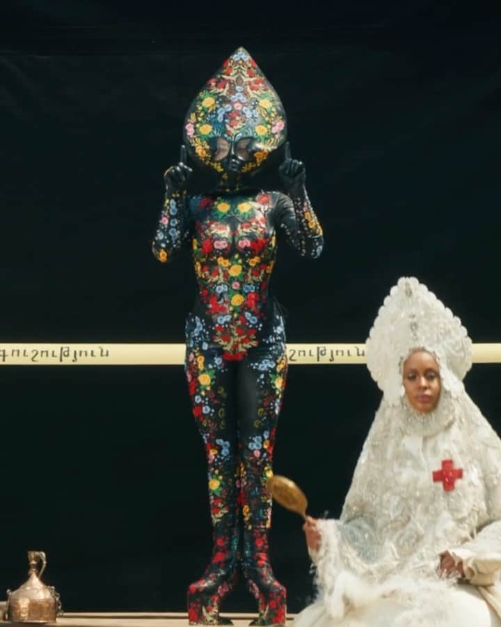 ニコラ・フォルミケッティのインスタグラム：「911 - Lady Gaga 🖤 Film by Tarsem Fashion by Nicola Formichetti   LG floral alien look -  @karinaakopyan_  SAINT @Nicole_docee Outfit @richardquinn Headpiece @agnieszkaosipa  Shoes from Universal Studio Costume  UMBRELLA MAN @siazami  Shoulder piece and belt @laureldewitt  Pants @jimtannerdesigns Coat @gelarehdesigns   FIRESPIRITS  @cakeflaps  @dannyoclark  @mandellfrazier  Brock cuchna  Full orange looks @garosparo」