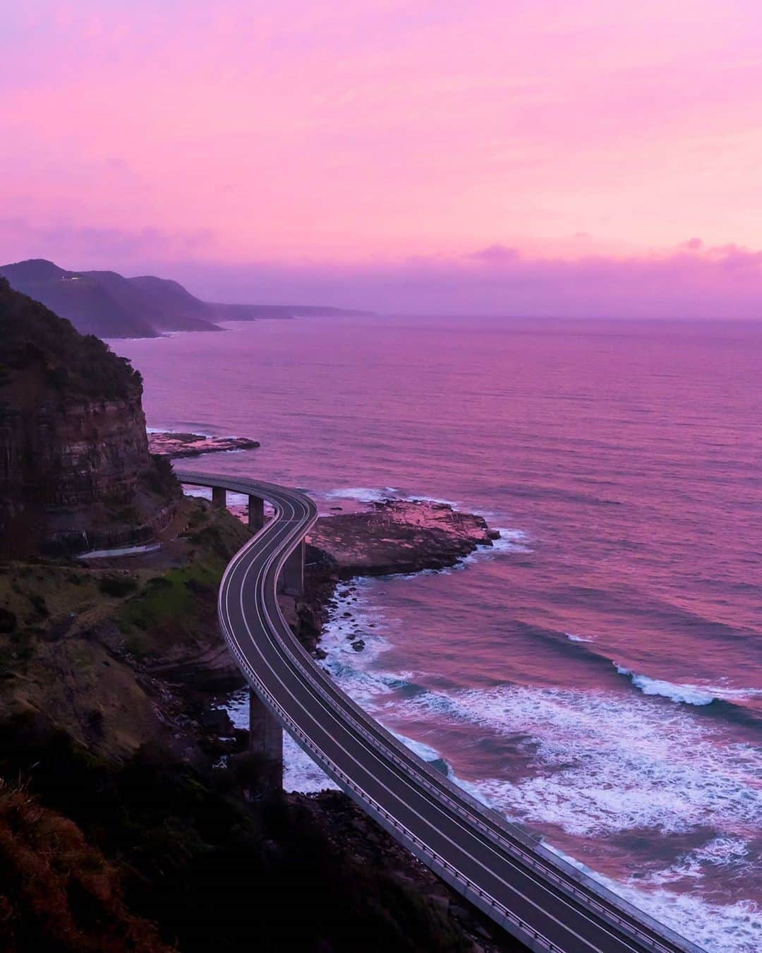 Australiaさんのインスタグラム写真 - (AustraliaInstagram)「Windows down, volume up - we’re going on a road trip 👌🏽 @mani.b.singh captured @visitnsw’s magnificent coastline at sunset recently featuring @grandpacificdrive, which is one of Australia's most spectacular coastal drives. Pictured here is the famous #SeaCliffBridge near @visitwollongong, around 90 minutes south of @sydney. If you're thinking of taking a #roadtrip, make a stop at the @kiamansw famous blowhole, then head to @diggiescafe for a prawn roll before you return to the road and head south towards the magnificent @visitshoalhaven region. #seeaustralia #NewSouthWales #LoveNSW #kiama」9月19日 5時00分 - australia