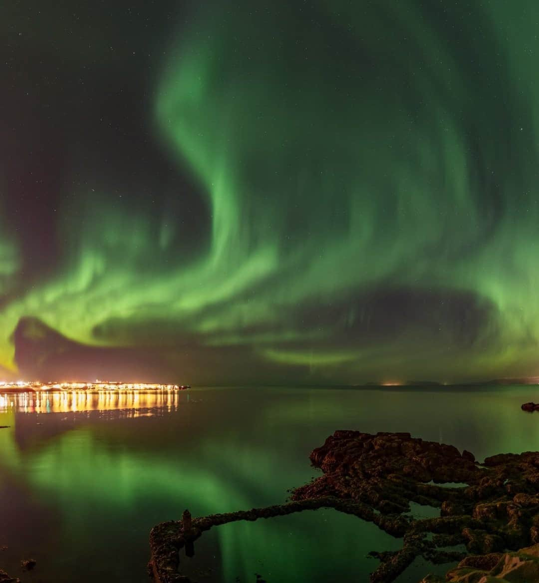 National Geographic Travelさんのインスタグラム写真 - (National Geographic TravelInstagram)「Photo by @babaktafreshi / Green flames seem to emerge from city lights. When an aurora is bright enough, it can be easily viewed from small cities, despite the skyglow. This was last year in the town of Keflavik, near Iceland's international airport. Learn more about the wonders of the night sky with me @babaktafreshi. #auroraborealis #northernlights #twanight #nightphotography」9月19日 17時08分 - natgeotravel