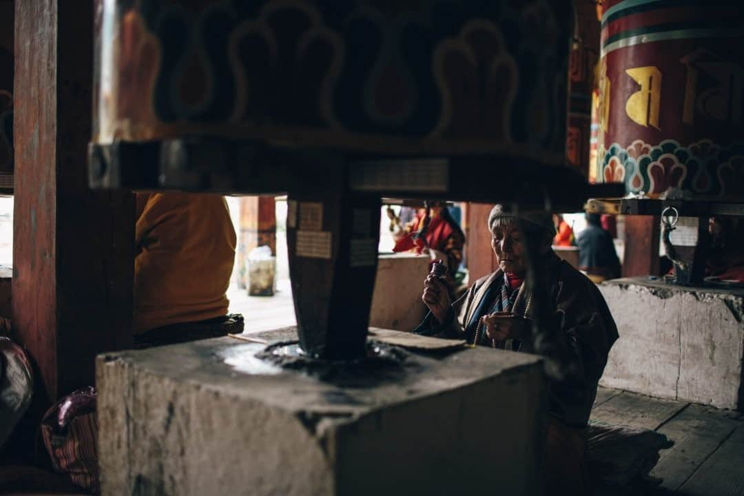 National Geographic Travelさんのインスタグラム写真 - (National Geographic TravelInstagram)「Photo by @joshuacogan / A pilgrim turns a prayer wheel and thumbs through mala beads at a temple in Thimphu, Bhutan. The physical acts that accompany the repetition of spoken mantra in Buddhism are intended to keep practitioners deeply engaged in the present moment. By doing so, it is hoped that we can release attachment to the future or the past, allowing us to fully experience each new moment with a beginner's mind.  For more pilgrimages around the world, follow me @joshuacogan. #Bhutan #Buddhism」9月22日 13時10分 - natgeotravel