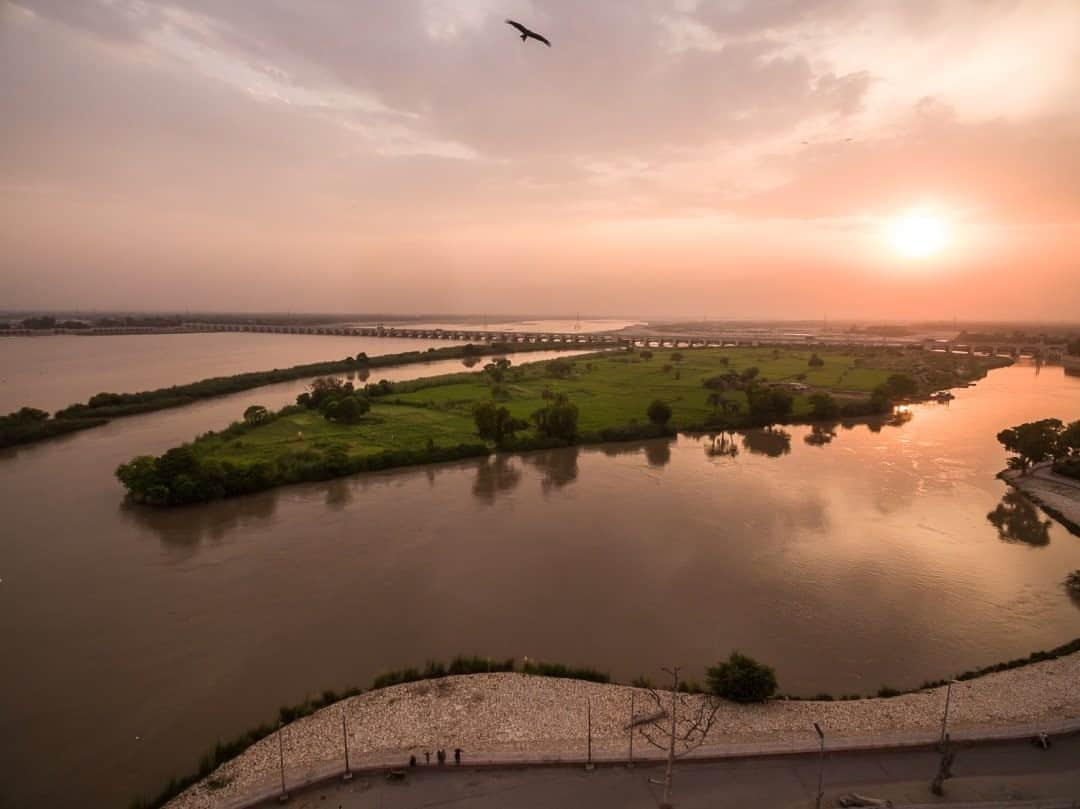 ナショナルジオグラフィックさんのインスタグラム写真 - (ナショナルジオグラフィックInstagram)「Photo by Brendan Hoffman @hoffmanbrendan / The Indus River and Sukkur Barrage at sunset in Sukkur, southern Pakistan. The Indus is one of Asia's most vital rivers, supplying water to hundreds of millions of people in its watershed in Tibet, Afghanistan, India, and Pakistan. The Sukkur Barrage (backgound) helps control water flow into the world’s largest canal system, snaking thousands of miles through fields of rice, cotton, wheat, and sugarcane, irrigating what would otherwise be a desert, to form the cornerstone of Pakistan’s economy. Follow me @hoffmanbrendan for more human stories from around the world. #indus #indusriver  #sindh #sukkur #pakistan  Check out Nat Geo's link in bio for more on this story.」9月23日 15時39分 - natgeo