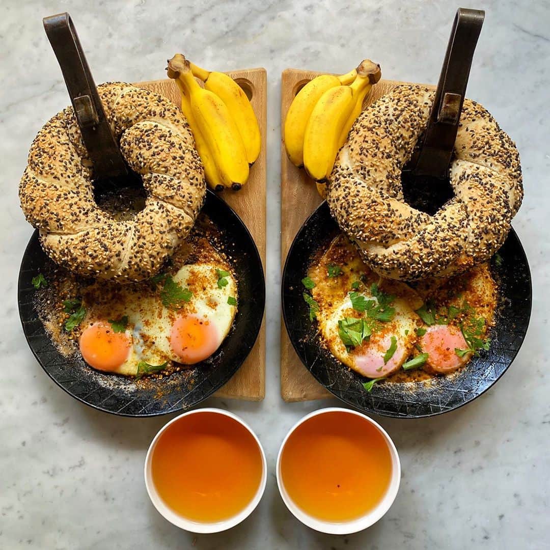 Symmetry Breakfastのインスタグラム：「Sunday Simit, a delicious braided Turkish bread, seems like a bagel, but no, it’s not boiled before being baked, usually with a crusty crunchy exterior rather than a chewy skinned bagel. These definitely need more work! Thinner and darker colour would be perfect. Served with eggs fried in sesame oil, butter and the last of my stash of Urfa chilli flakes I got in Turkey last year. Mini bananas 🍌🍌🍌to finish because they’re cute...like me 😂 #simit #turkishfood #symmetrybreakfast」