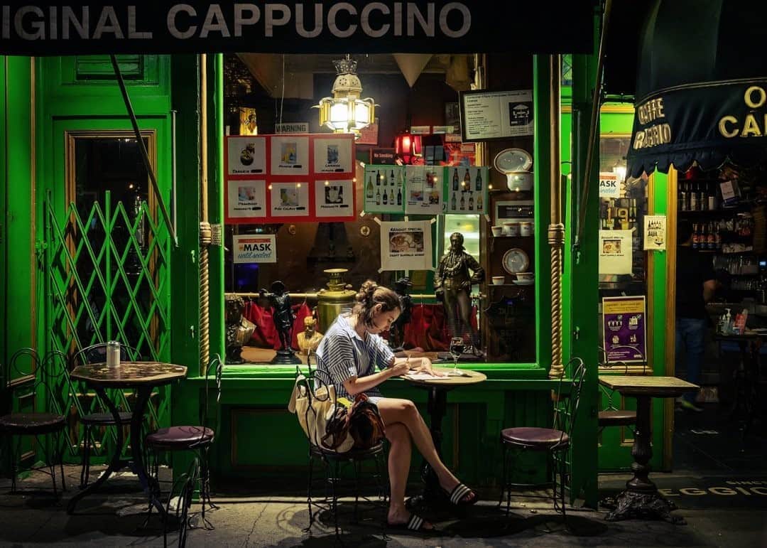 National Geographic Travelさんのインスタグラム写真 - (National Geographic TravelInstagram)「Photo by @dina_litovsky / A woman sits at Caffe Reggio, the legendary Greenwich Village coffeehouse dating back to 1927. Outdoor dining is in effect in New York City, and people are enjoying the city’s streets once again. For more images of night in NYC, follow me @dina_litovsky.」9月28日 17時09分 - natgeotravel