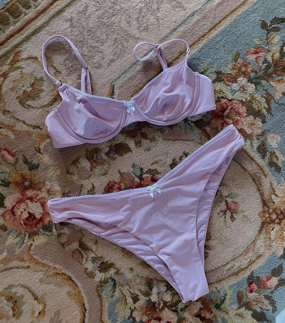 We Wore Whatさんのインスタグラム写真 - (We Wore WhatInstagram)「Lavender 💜  So much goes into these swim collections and I wanted to take a moment to explain the design process to you guys, which happens a FULL YEAR in advance. A 3am idea pops into my head for a theme (boudoir collection), and from it we begin.. I flip through my Pantone color book for hours, tearing out my favorites and putting it all together with a mood board. From there I meet with my design team which consists of technical designers, art designers, fit experts, fabric sourcing, CAD specialists, and more.. we pull all our previous shapes and decide how we want to update them and discuss new styles to add. We review customer feedback to see what we are missing (ie: skimpier bottoms and more bust coverage). From there the CAD designer starts to put our ideas into action, while the new fabrics get sourced, and lab dips of our new core colors begin. My incredible art designer presents dozens of options for all of my print ideas and we sit together meticulously going through the details of every print. There are several rounds of iterations until the prints are perfect and we go into “strike offs” to receive small swatch samples. Then we begin fittings on available color fabric with our experienced fit model and then the team creates tech packs for our production. Once we have finalized prints and shapes, we CAD all the prints in all color and style options. I sit with the hundreds of little cutouts and choose which suits I want to actually go into production on (this part is how we make it look like a fully merchandised collection). We put all my selects together on a line sheet and make edits. I want everyone’s opinions and input, always. Showroom samples come next which is what we show to buyers, we make last minute changes and any cuts or additions. From there we get PP samples (pre-production) for final final approval! I sit with my business partners and actually plan the buy too. I pick the pieces I think I will wear most but will also popular based on current trends, and we buy the most quantity of those. It’s predictions at best but based off retail math and past sales. [continued in comments]」9月29日 22時15分 - weworewhat