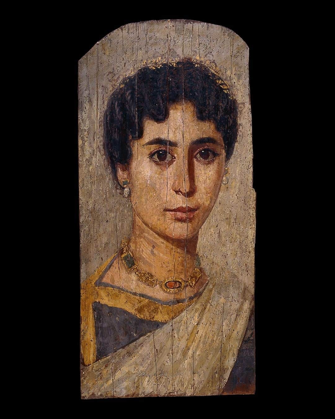 のインスタグラム：「‘Mummy portraits’ like this became fashionable in the late first century BC in Roman Egypt.   After the Battle of Actium in 31 BC, Egypt became part of the Roman Empire and realistic paintings of people’s faces on wooden panels – 'mummy portraits' like this example – became the new trend for burials.   The painted panels were secured in linen wrappings or in a cartonnage (layers of linen mixed with plaster) and placed over the face of the underlying mummy, before being buried in a sealed tomb.   In our latest blog, scientist Caroline Cartwright investigates how these fascinating objects were made, and finds out what they can tell us about the people they portray – link in bio.   🔎 Lime wood portrait of a woman. Roman Period Egypt, AD 160–170.  #AncientEgypt #BritishMuseum #Science #Conservation」