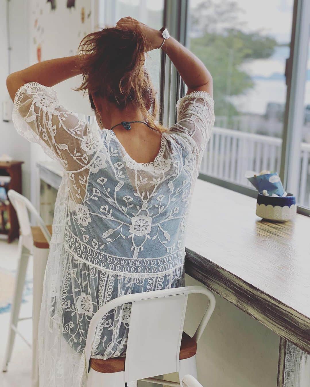 三谷晶子のインスタグラム：「友人からいただいたデニムサロペットと、古仁屋の居酒屋・神鷹の不定期フリーマーケットで買ったレースガウンで、LAを意識してみた本日のわたし。  ピアスは　@harahabuya さんの最近のお気に入りです✨  Shooting location : @kakeromacafe   #加計呂麻島 #かけろまカフェ  #cordinate  #salopette  #denim  #denimstyle  #gown #lace  #lacegown #harahabuya」