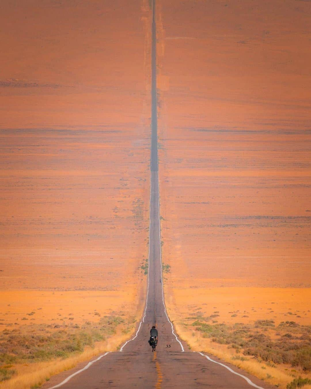 Discover Earthさんのインスタグラム写真 - (Discover EarthInstagram)「Let's hit the road! ————————————— " Nevada is not what I expected. When I thought about biking through this state all I could imagine were flat beds of sand in the beating sun. In reality, it is like Colorado, but more tan, and straighter roads.  Our rides consist of a series of mountain passes followed by valleys. At the top of each pass, the next desolate valley awaits, just like the last, inducing a sort of deja vu experience. This image was shot in one of those valleys, and you can see how this straight road dips down, then right back up into the mountain pass. It was captured at 600mm, giving it this surreal perspective. No photoshop here." 🇺🇸 #discoverNevada with @hytha.cg  #ontheroad #valley #nevada」10月7日 1時00分 - discoverearth