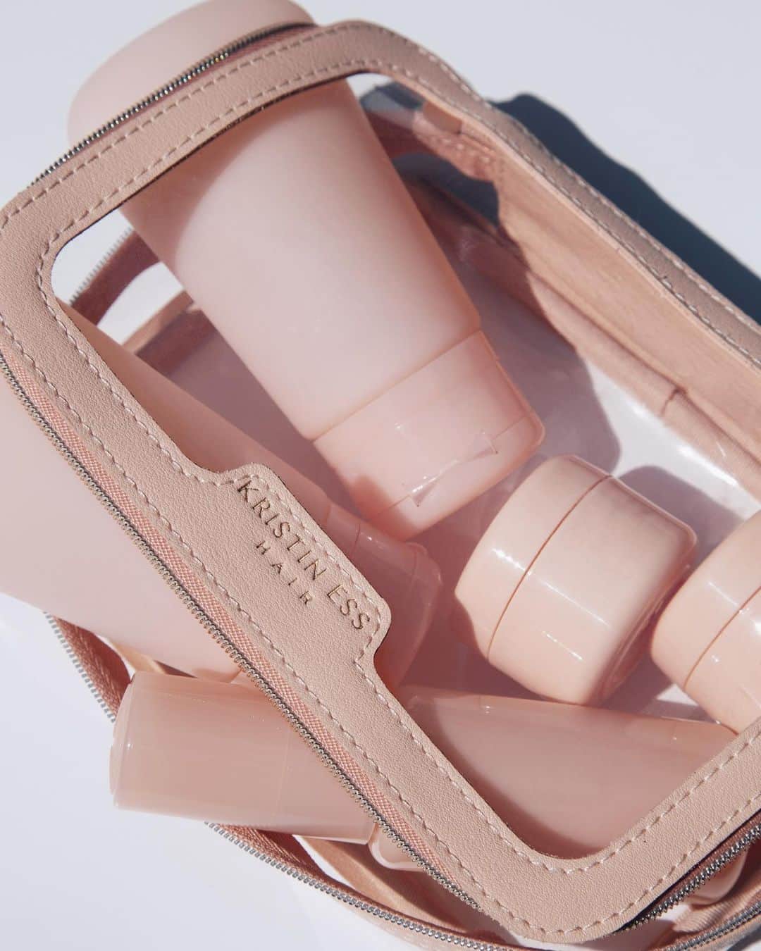 Kristin Essのインスタグラム：「It’s the pink vegan leather for me 🐰 Instead of making minis for all of my products, I thought it would be smarter (and far more eco-friendly) to let you do it using whatever products you want to take with you. This set comes with 2️⃣ refillable silicone squeeze bottles 2️⃣ refillable jars + 1️⃣ refillable spray bottle inside the cutest case. You also get reusable labels which will help you keep things organized! This will be available ONLY on target.com for $20 starting 10/25. (Update: now launching 11/8 on target.com}」