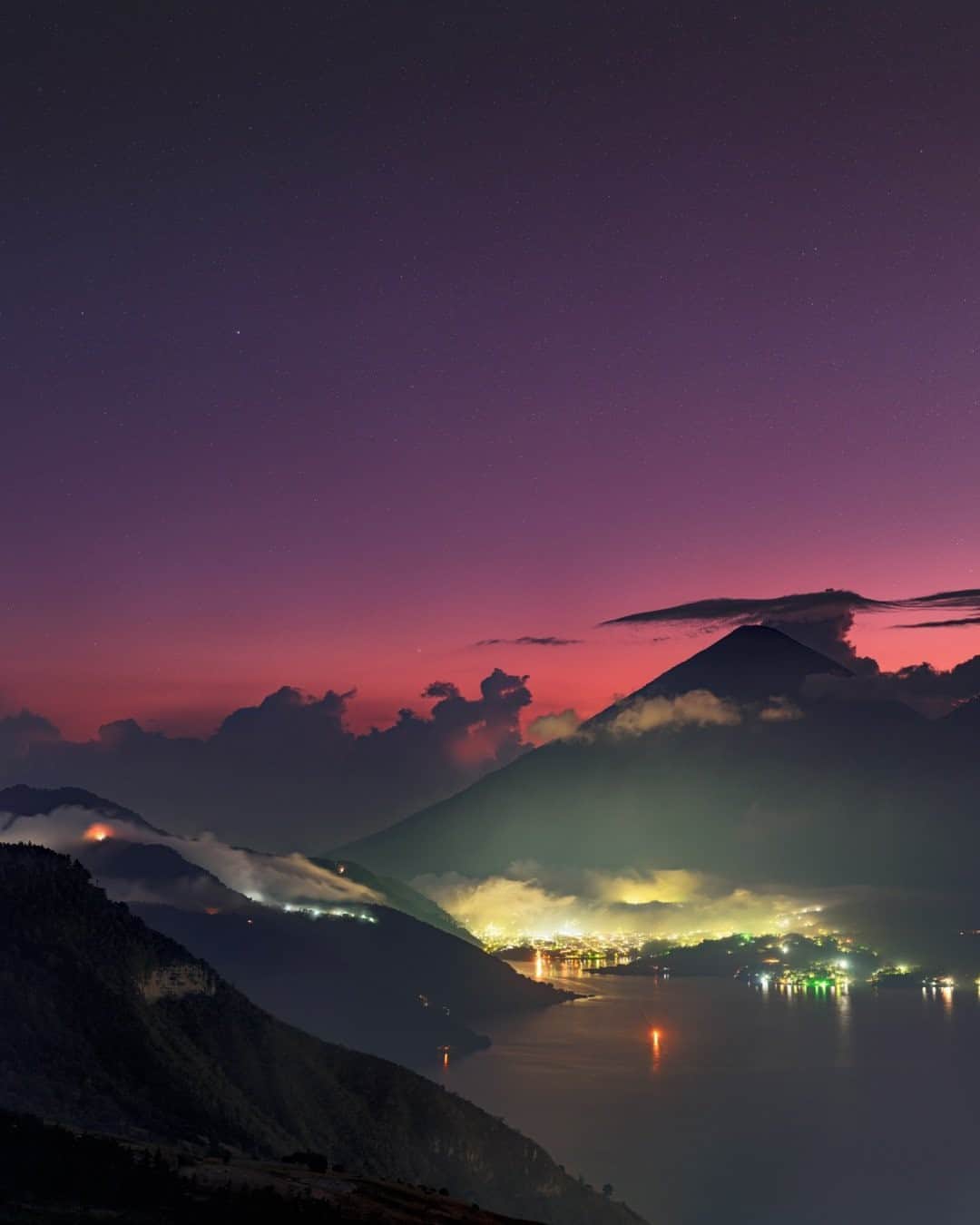 National Geographic Travelさんのインスタグラム写真 - (National Geographic TravelInstagram)「Photo by @babaktafreshi / A night begins with stars emerging above a volcano on Lake Atitlan. The color of dusk in this tropical latitude is more vivid than usual due to ash and dust scattered in the sky from an erupting volcano nearby. The shore of this sacred lake is home to Maya communities in Guatemala. Explore more of the world from dusk to dawn @babaktafreshi. #twanight #atitlan #guatemala #volcano」10月8日 21時07分 - natgeotravel