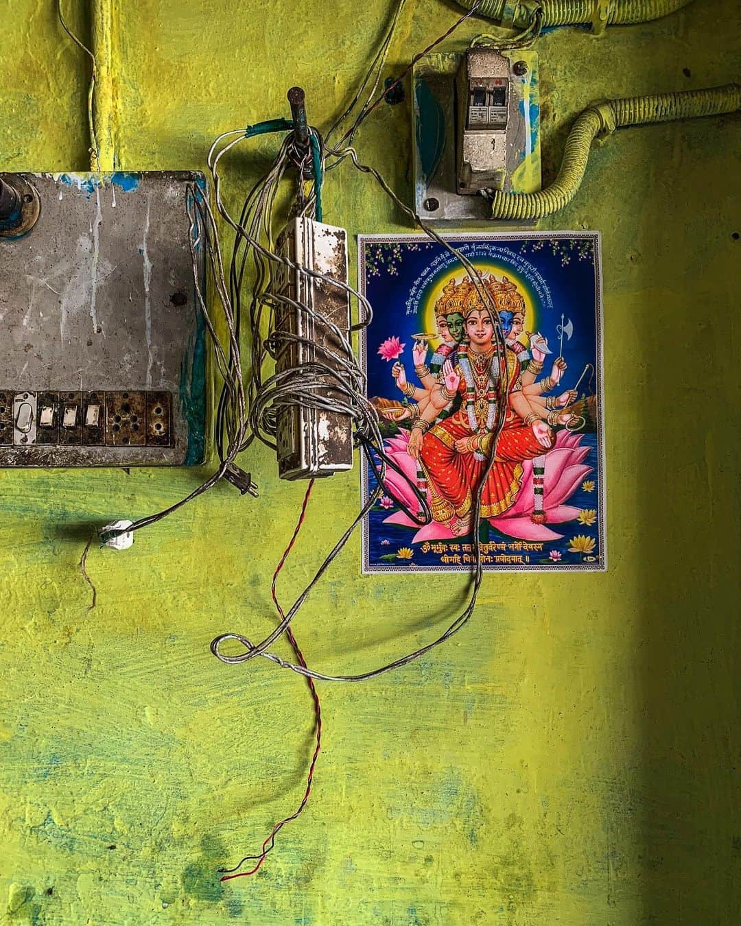 のインスタグラム：「Around and within all the confusion of India. All the mind-boggling astonishingness. Everywhere you will find electrical spaghetti. All over is the chaos theory of electrical dynamics. Still, in each hotel and dhaba where I saw spaghetti, everything worked! Maybe it helps when Goddess Gayatri Devi oversees a tangled power strip and switch box at a hotel I slept at in Seondha in Madhya Pradesh. No gods or goddesses protected a bursting box with flavorful colored tagliatelle at another hotel in Bhagalpur, Bihar, and still, all the lights worked just fine. It takes patriotism to keep the power flowing and listing switch box from bursting into flames at a dhaba we had dal for breakfast, walking distance from the hotel in Bhagalpur. These days, the real chaos is us. How no one is paying attention to the war in the #Caucasus #NagornoKarabakh. We're still doing almost nothing about our environment. Too many people are more fascinated with a fly landing on the head of Whose Name I will not mention, accepting tangled lies and deceit in politics. And Us vs. Them is spreading. Now please… don't ever say beautiful India is backward when in truth, our entire human society is more messed up than any circuitry in all of South Asia. Sitting tonight on #thepurpleporch, making triptychs, missing Indian pasta... ⠀⠀⠀⠀⠀⠀⠀ India’s Daunting Challenge: There’s Water Everywhere, And Nowhere - Chapter 8 of the @outofedenwalk, my latest story in the August 2020 of @natgeo magazine. ⠀⠀⠀⠀⠀⠀⠀ #triptych #circuitry #electricity #electricalboxes #fusebox #beautiful #chaos #yellow #pink #green #nothingspecial #peace #love #seondha #madhyapradesh #bhagalpur #bihar #india @natgeo @outofedenwalk #walkingindia #edenwalk」