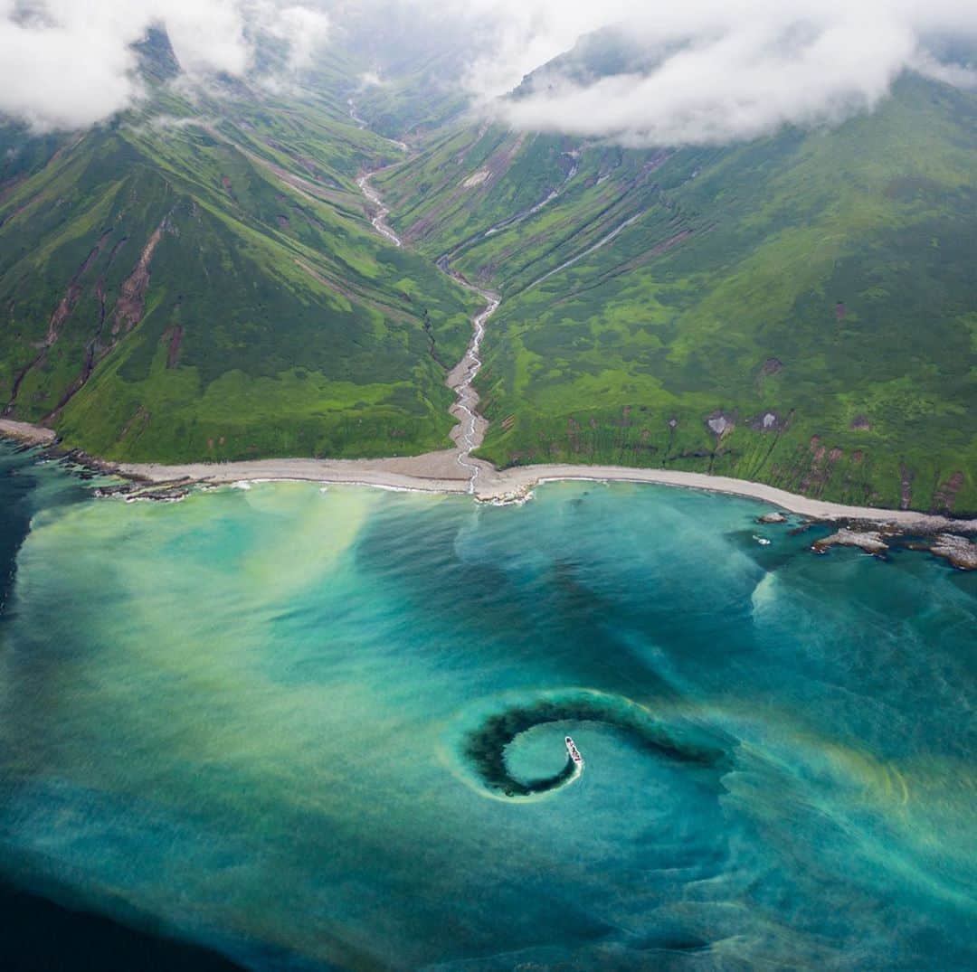 クリス・バーカードのインスタグラム：「Some places leave us with more questions than answers. The Kuril Islands are on of those places. Seemingly not of this world in terms of beauty and remoteness. @taylorfreesolo ‘a film “From Kuril’s with Love” attempts to dive into the complex issues these islands face. I was lucky to be apart of that prodction team & help tell the story of our Russian stowaway Vladimir Burkanov whose scientific research has spanned over 30 years in these islands.  This film seems maybe more important than ever given the recent chemical spill in Kamchatka. This image was taken in the Kurils and the water color is natural runoff from a large hotspring in the Mtns.」