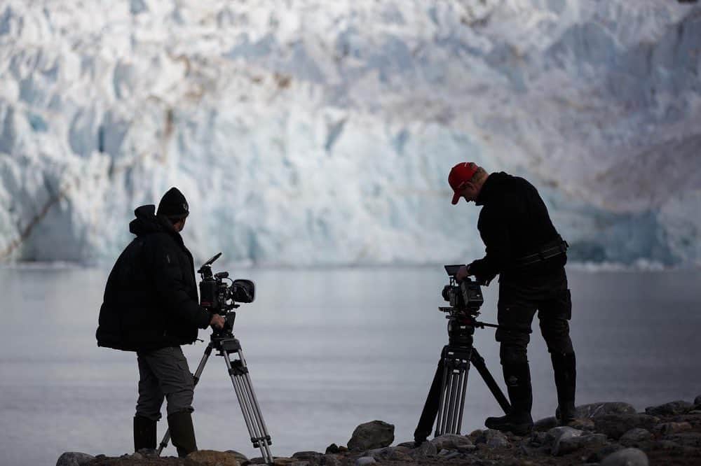 thephotosocietyさんのインスタグラム写真 - (thephotosocietyInstagram)「Photo by @nickcobbing   A watched glacier never calves! Well it usually does if you watch it long enough. My friend and colleague @richardkirbyphotography with his assistant Tom, waits patiently with two cameras set on pre-roll. The tripods are heavy and it's not an easy place to get to, so the pressure is on to get results. Fortunately the sun falling on the glacier helped things along and a lot of ice broke off into the sea that day. The second picture shows what can happen if you wait long enough.  These pictures were taken on Svalbard where although calving is normal, the rate at which glaciers move ice mass towards the ocean is rapidly increasing. The climate of the Arctic archipelago is changing fast. Increased calving reduces ice cover, transports more freshwater into the ocean and radically changes the habitat for the wildlife of the area.  #arctic #glacier #landscape #svalbard #filming #climatechange」10月14日 21時22分 - thephotosociety