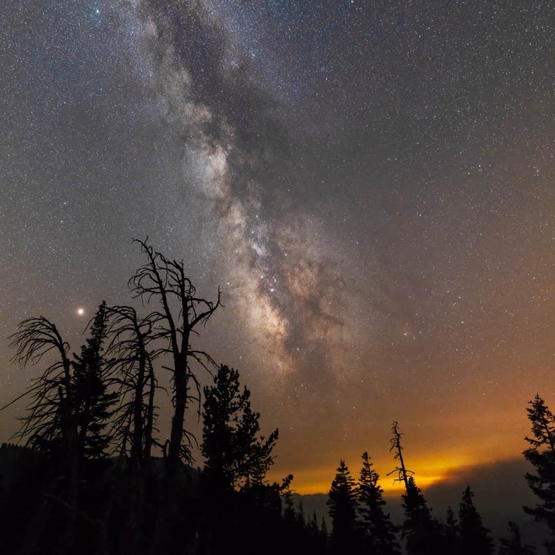 National Geographic Travelさんのインスタグラム写真 - (National Geographic TravelInstagram)「Photo by @babaktafreshi / The massive wildfire in the far distance was glowing like a city in the air on this summer night in the Sierra Nevada, California, two years ago. At over 10,000 feet (3,000 meters) of elevation, I was high enough to clearly see the Milky Way through a thin layer of smoke. Explore more from Earth to the universe with me @babaktafreshi. #twanight #wildfire #earth #california」10月15日 11時35分 - natgeotravel