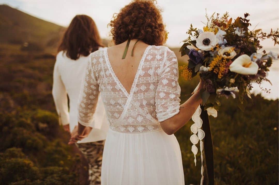ミナのインスタグラム：「Photographers Jess and Karolyn from @honeyandthemoonphotography got married before same-sex marriage was legalised in their native Northern Ireland. They decided to elope and get married in the Big Sur in California, USA. Jess was wearing our beautiful Brie dress. You can see all the amazing images of their elopement wedding and also find their engagement pictures on the website of the photographer @nessakphotography. ❤️ Link in bio.⁠ ⁠」