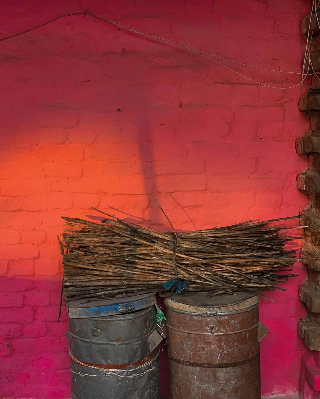 ジョン・スタンメイヤーさんのインスタグラム写真 - (ジョン・スタンメイヤーInstagram)「Two chairs, two green flip-flops, two tin cans, things in pairs stumbled upon in India… Chairs outside the dripping orangey-red prayer tent in the ashram we stayed during the 2019 Kumbh Mela in Prayagraj, Uttar Pradesh… @ankitha_rs’s green flip-flops, outside her door at the reddest of red hotels ever in Borjhar, Assam… Two trash cans at a home in Bhind, Madhya Pradesh, resting against a mighty pink wall when the light kissed it yellow near sunset. Once again, all #nothingspecial, until noticing magical patterns before all of us, coming as one together. ⠀⠀⠀⠀⠀⠀⠀ India’s Daunting Challenge: There’s Water Everywhere, And Nowhere - Chapter 8 of the @outofedenwalk, my latest story in the August 2020 of @natgeo magazine. ⠀⠀⠀⠀⠀⠀⠀ #triptych #pink #red #chairs #prayagraj #allahabad #UttaraPradesh #green #flipflops #blue #curtain #borjhar #assam #tincans #sticks #sunlight #bhind #MadhyaPradesh #peace #love #india @natgeo @outofedenwalk #walkingindia #edenwalk」10月20日 10時17分 - johnstanmeyer