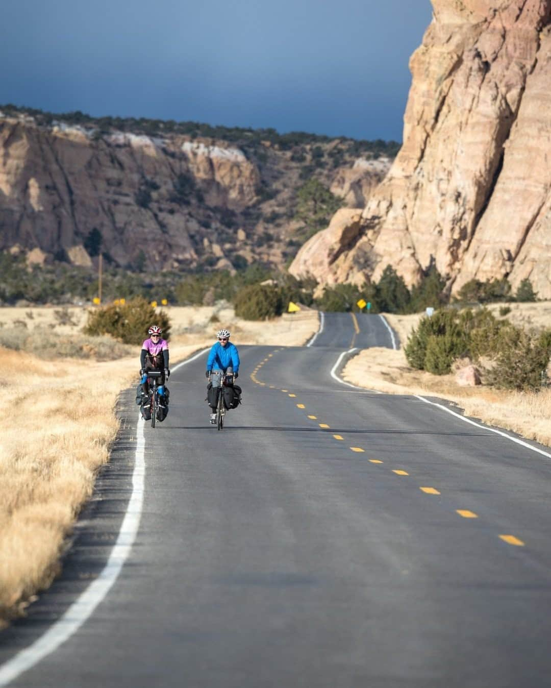 National Geographic Travelさんのインスタグラム写真 - (National Geographic TravelInstagram)「Photo by @michaelclarkphoto / Patrick O'Grady and Owen Haggard bike just south of Grants, New Mexico. Bike touring is easily one of the most incredible forms of travel. Taking in the scenery at a slower pace, pushing your body to get up that next hill, and then eating as much food as you can scarf down are all just part of the fun. There can also be some serious suffering on the bike—especially in poor weather—but that is part of the grand adventure. I have never matched the sense of freedom I have experienced while bike touring; the closest was probably sea kayaking. #biketouring #newmexico #adventurecycling」10月22日 3時36分 - natgeotravel