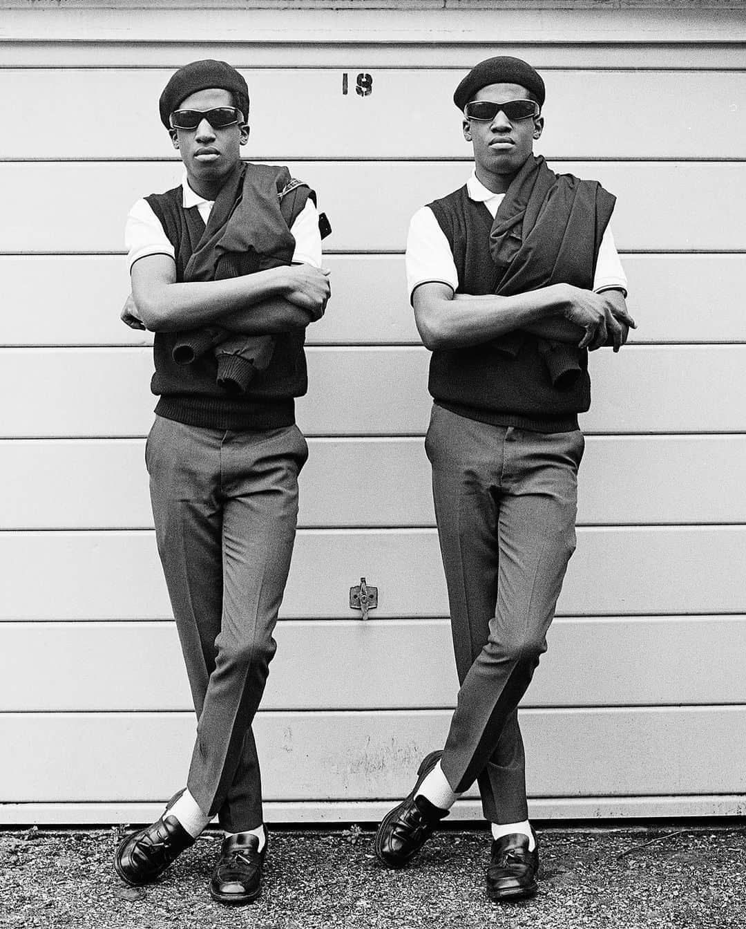 AnOther Magazineさんのインスタグラム写真 - (AnOther MagazineInstagram)「The Islington Twins by @janettephoto, London, 1980 👬⁠⠀ ⁠⠀ “In London in the 1980s, the Islington Twins (Chuka and Dubem Okonkwo) would meet every evening at rush hour at ‘The Bar’ with a crowd of teenage followers,” remembers Beckman. “‘The Bar’ didn’t serve food or drink; there was no jukebox or seating. It was just a horizontal pole that stopped cars from entering the road to the local Highbury & Islington Tube station. Always identically and impeccably dressed, the twins played music by bands like Madness, The Specials, and Bad Manners on their boombox ... For them, being a mod was more than just clothes. It was the way you conducted yourself and behaved toward others.” This image features in the @magnumphotos Square Print Sale, link in bio 📲」10月23日 2時25分 - anothermagazine