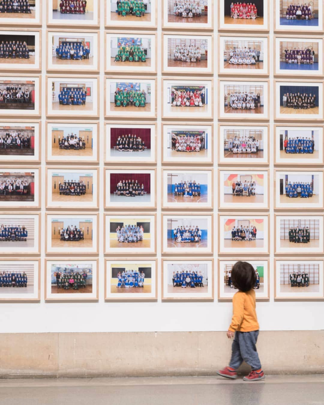 テート・ギャラリーさんのインスタグラム写真 - (テート・ギャラリーInstagram)「A little visitor exploring the thousands of children's faces in Steve McQueen's #Year3Project, offering a glimpse of his future -- a portrait of his fellow young Londoners. ​ The project features class portraits of over 76,000 year 3 students, covering every borough in the city.⁣ ⁣⁣The artist considered year 3 age (between 7 and 8 years old) to be a key milestone in a child’s development and their sense of identity. It’s a time for them to develop confidence in all areas of life, to understand more about their place in a changing world and to think about what their future might be like. The installation captures a moment of excitement, anticipation and hope in the lives of these 76,146 children.⁣ ⁣⁣ ​ Steve McQueen’s #Year3Project is a partnership between Tate, @artangel_ldn and A New Direction, ​on free display until 31 January 2021.」10月25日 20時18分 - tate