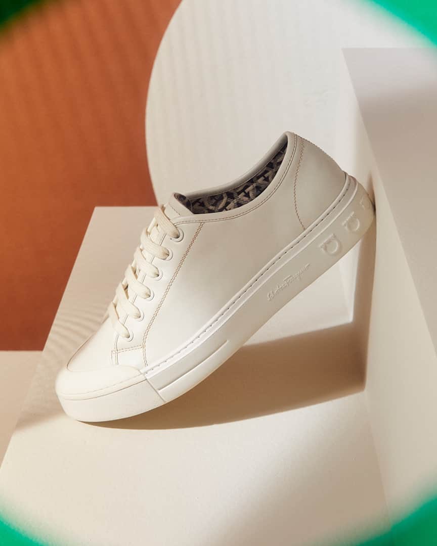 サルヴァトーレ・フェラガモのインスタグラム：「Characteristic of a visually striking Autumn Winter 2020 collection, objects are shot through defocused symmetrical impositions in the foreground, challenging the eye to search out its subject. Classic lace-up tennis sneakers acquire a touch of sports-glam with the gancini signature lining the inside. #FerragamoAW20」