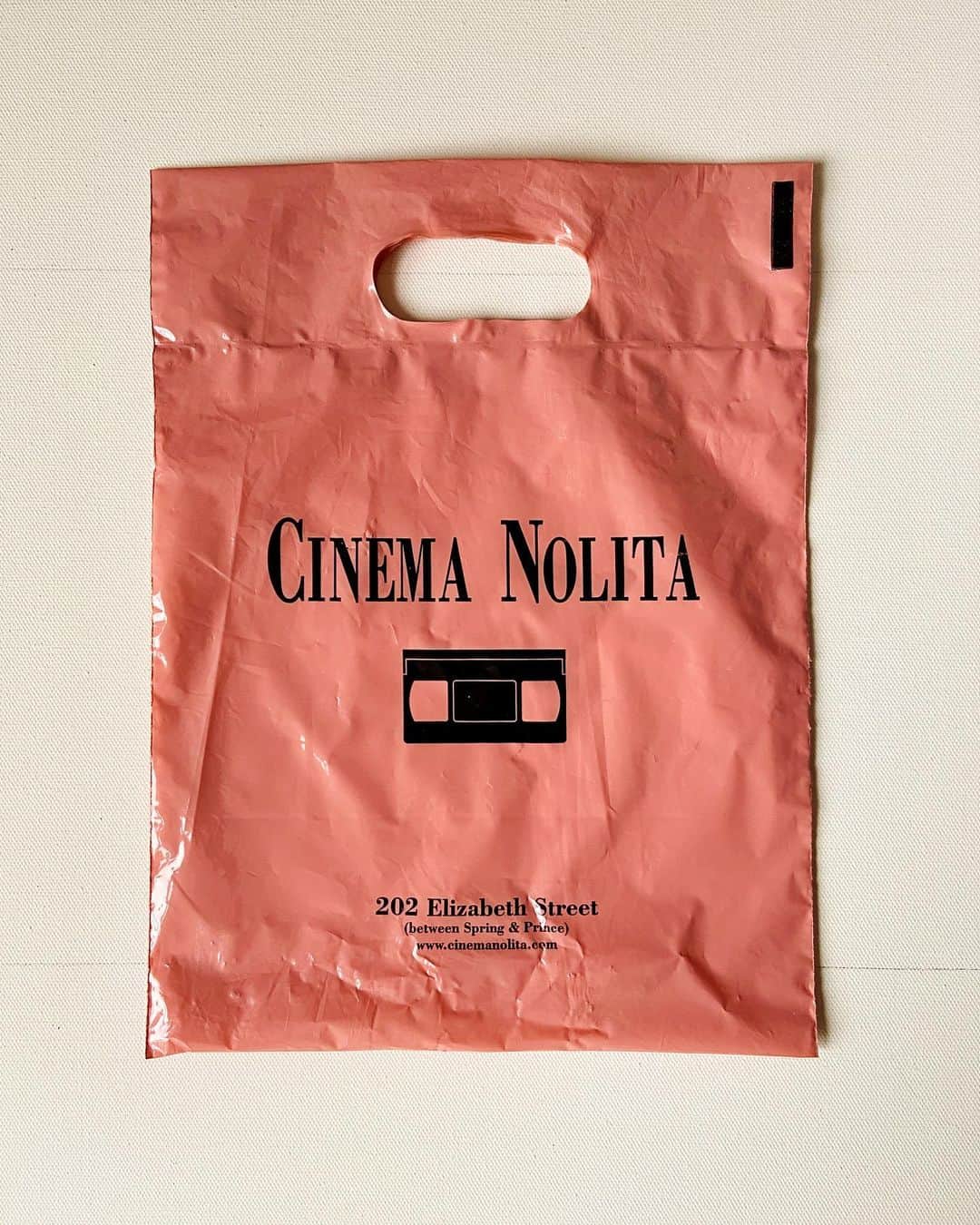 ケンゾーミナミのインスタグラム：「I have been clearing my stuff so I have been constantly finding random things I intentionally or unintentionally kept around for ages. (And relentlessly and mercilessly throwing them away. Though I might keep this one...) I don’t know which category this fits in, but I used to love this place and this is from when I used to live a few blocks away from it in Nolita when the neighborhood still had this small village communal feeing and loved living there among people that I loved. One of my regular routine was to go here and pick up a movie, and stop by @lovelydayny to take out the dinner to eat as I watch it. I resisted joining Netflix for years back then because I wanted to keep my excuse for this routine and going to this place. It’s long gone now, but I hope people who put that place and its curation together know that they had fans and their effort were not lost on people.  Also, I guess they were doing #millenialpink before #millennial even were doing it. (Or even existed.)  #cinemanolita」