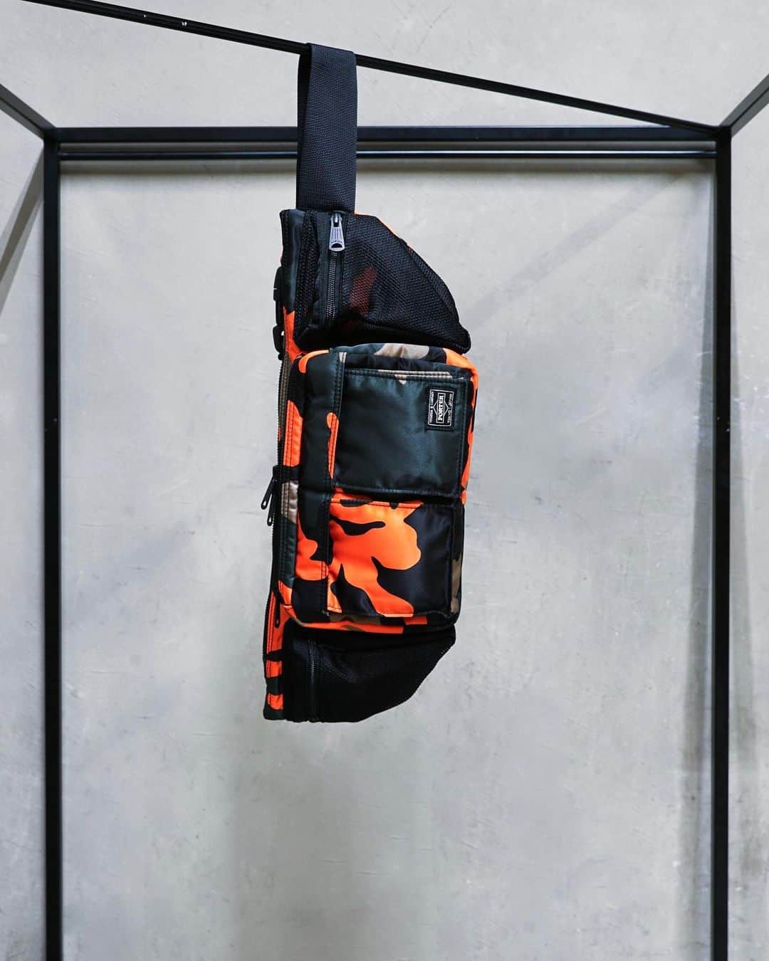 のインスタグラム：「.﻿ SHOP ORIGINAL﻿ PS CAMO﻿ ﻿ ウッドランドパターンのカモフラージュ柄に、ビビットなオレンジカラーを取り入れたPORTER STANDオリジナルシリーズ。﻿ ﻿ 薄マチでありながら、細かな収納ポケットを多数装備した機能性の高さも特徴です。﻿ ﻿ WAIST BAG﻿ No.384-05757﻿ ￥20,000+tax﻿ W480/H170mm﻿ ﻿ #yoshidakaban #porter #luggagelabel #madeinjapan #japan #porterstand #shinagawa #tokyo #kyoto #ps #camo #waistbag #limited #exclusive #吉田カバン #ポーター #ポータースタンド #品川 #東京 #京都 #限定 #ウエストバッグ」