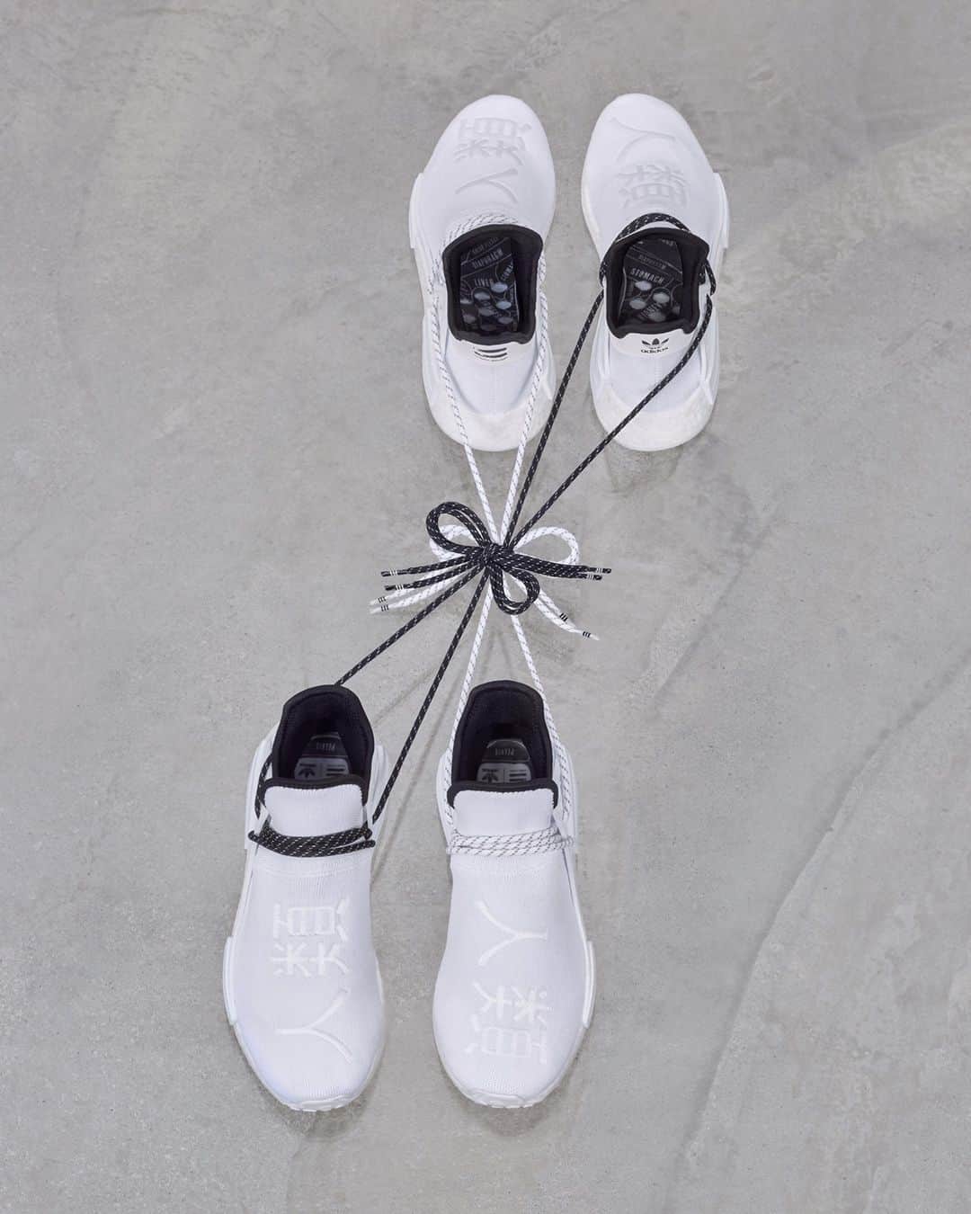 adidas Originalsのインスタグラム：「A brand new, striking white colorway of the PW HU NMD Sneaker has landed.   Courtesy of adidas Originals x @pharrell, this stripped-back model features a bold stitched graphic which reads ‘Human Race’ in Chinese. The sneaker is equipped with a BOOST midsole and Primeknit upper as well as co-branded sock liners. Available November 25 on adidas.com/pharrell, via the Confirmed app, and through select retailers.」