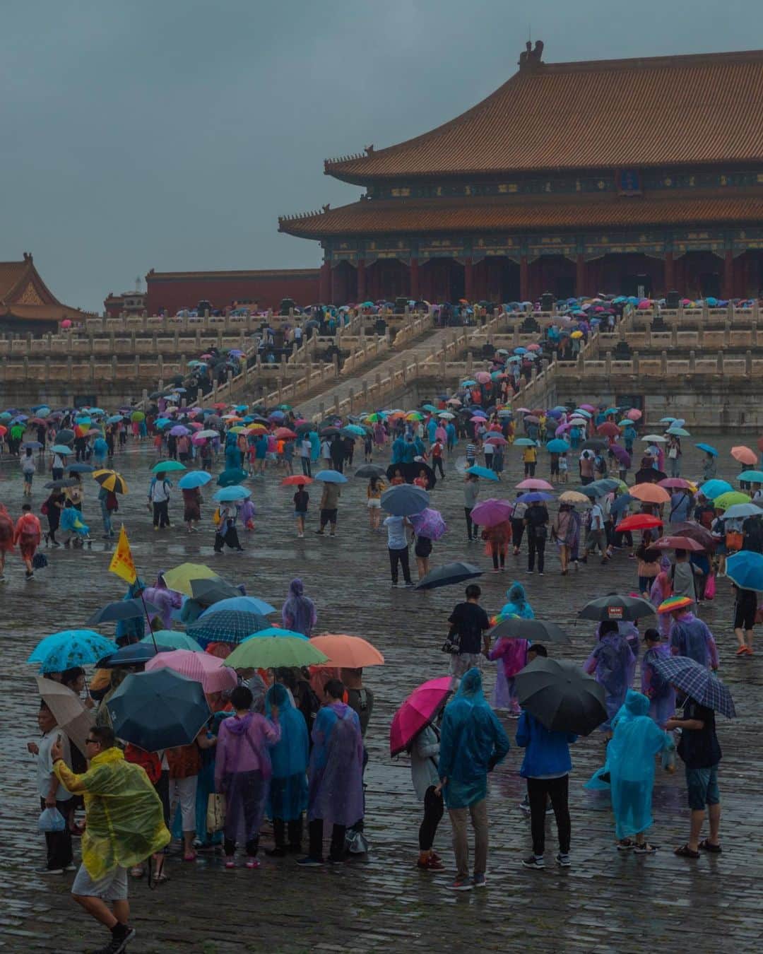 Putri Anindyaのインスタグラム：「a colorful forbidden city //   I remember it was a very very stormy day. The rain didn’t stop that morning but we had Forbidden City in the schedule. For someone who loves history so much, I’ve been longing to visit this place and the rain didn’t feel like a burden for me. Funny thing, I took a lot of pictures here and just edited them days ago. Two and half years just sitting inside my harddisk without any urge to edit these photos. When I try to edit it, I realized how gloomy it was that day so I adjusted with the umbrella colors instead. I feel happy with the results though it’s so contrast with the expression of the strangers who got soaked in the rain.   Which slides that got your eyes? 👀」