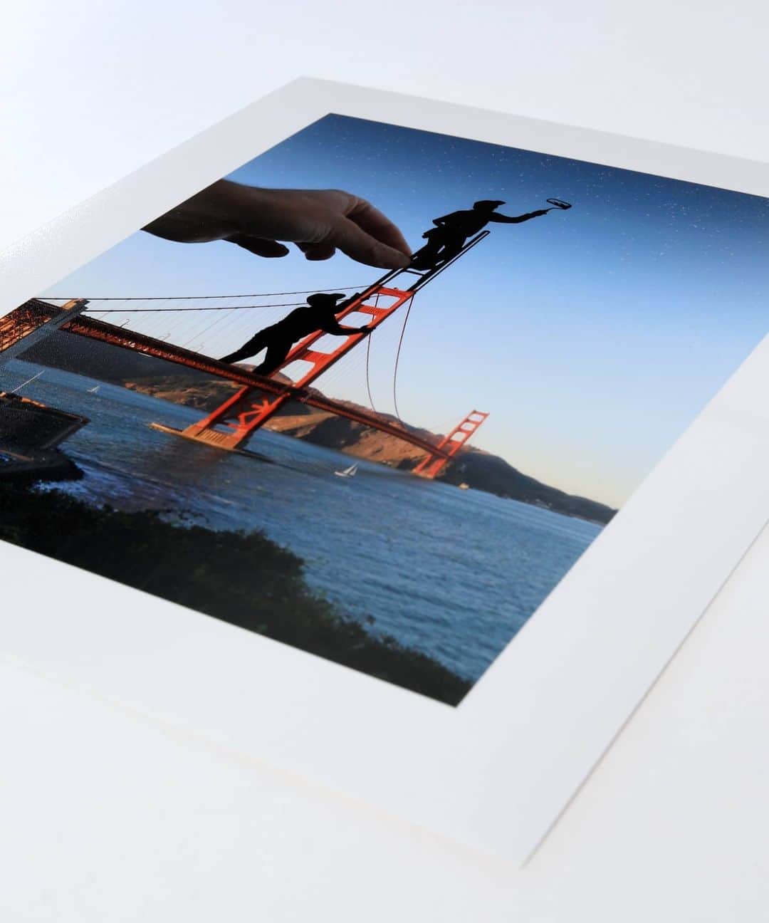 Rich McCorさんのインスタグラム写真 - (Rich McCorInstagram)「The Paperboyo print store - paperboyoprints.com - has over forty of my favourite prints in various sizes, including a new edit of my Golden Gate Bridge image.   I still love my original edit but when I sat down with the print team (virtually of course), I wanted to create a version that was more suited to being a portrait print. So I went back to the rushes that I shot in San Francisco and re-designed a paper cutout of the man on the ladder painting stars in the Californian sky above.   You'll find a few new versions of my images in the paperboyo print store and as well as re-edits, every image has been treated by an image retoucher so that they look their absolute best when printed out for you.   Head to paperboyoprints.com to see the selection.」11月23日 1時31分 - paperboyo