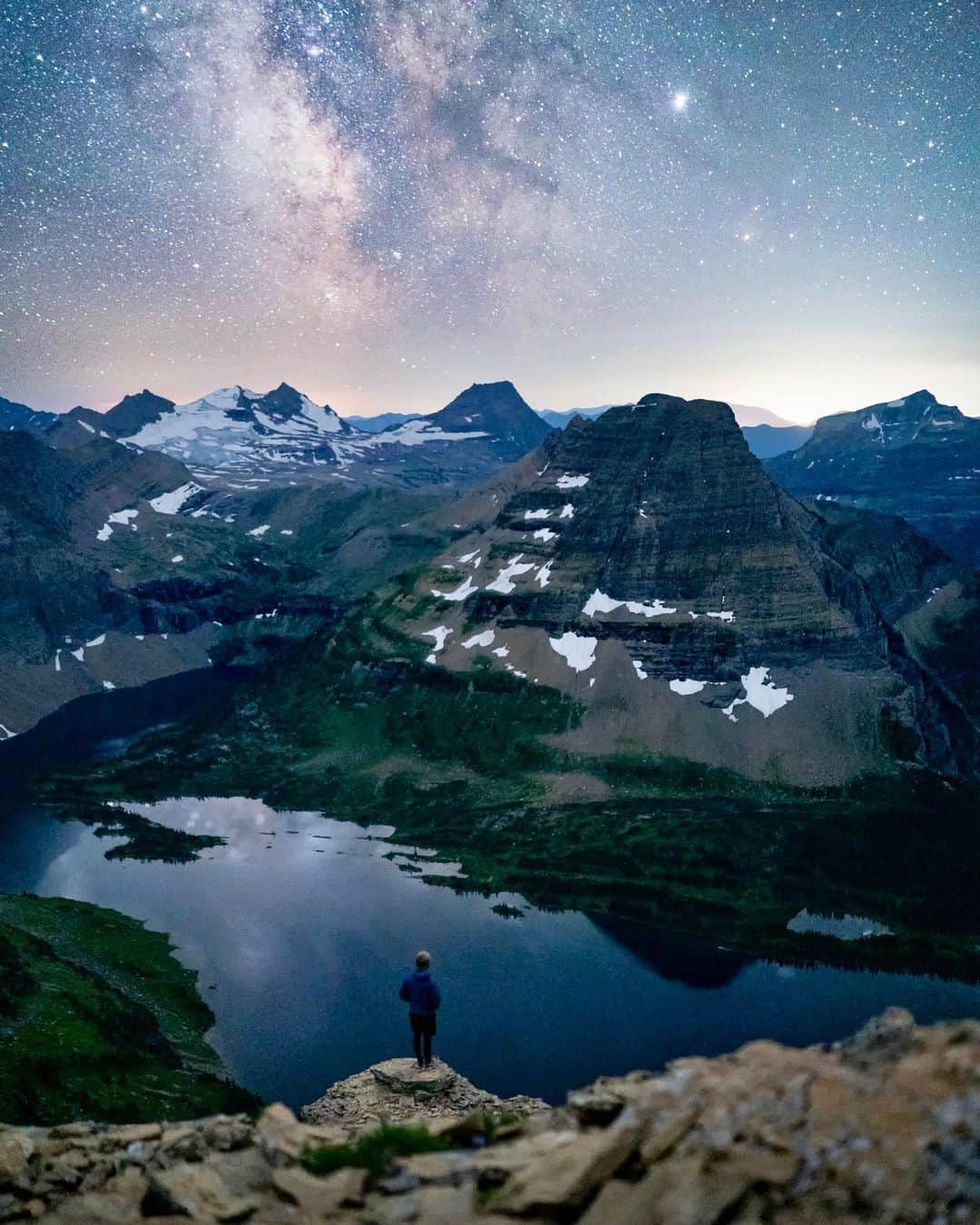 Travis Burkeさんのインスタグラム写真 - (Travis BurkeInstagram)「I knew right after this self portrait that I would have to spend the next few hours hiking alone through grizzly bear territory, scrambling down cliffs with sketchy 2,000 ft (600m) drops on either side. Each time I rounded a turn the bushes looked like bears and every noise grabbed my attention making me question what I was hearing. ⠀ Not only was this pushing the limits of my comfort zone but it was also one of the most beautiful night scenes I have ever seen and certainly one of the most difficult for me to photograph!  ⠀ Photo Details/Settings-  With no light pollution, the valley was so dark that I actually had to take an exposure that was over a minute and a half to capture the detail down there. This was one of the few times I've had to bracket exposures in a night scene but it’s what was necessary to capture everything the way my eyes saw it.  ⠀ Landscape- f/2, ISO 8000, 95 second exposure.  Universe above- f/2, ISO 6400, 20 second exposure. ⠀ I debated even posting this picture for a long time. It's noisy and I’m not super sharp in the photo (try holding still for 95 seconds in the dark with some wind blowing haha). I never want to encourage people to do things that aren’t safe, but it also represents a lot of things that I love. Adventures like this are a big part of what excites me, I learn a lot about myself and my craft, and ultimately experiences like this are what helped get me to where I am today! ⠀ #milkyway #montana #nightphotography」11月23日 7時16分 - travisburkephotography