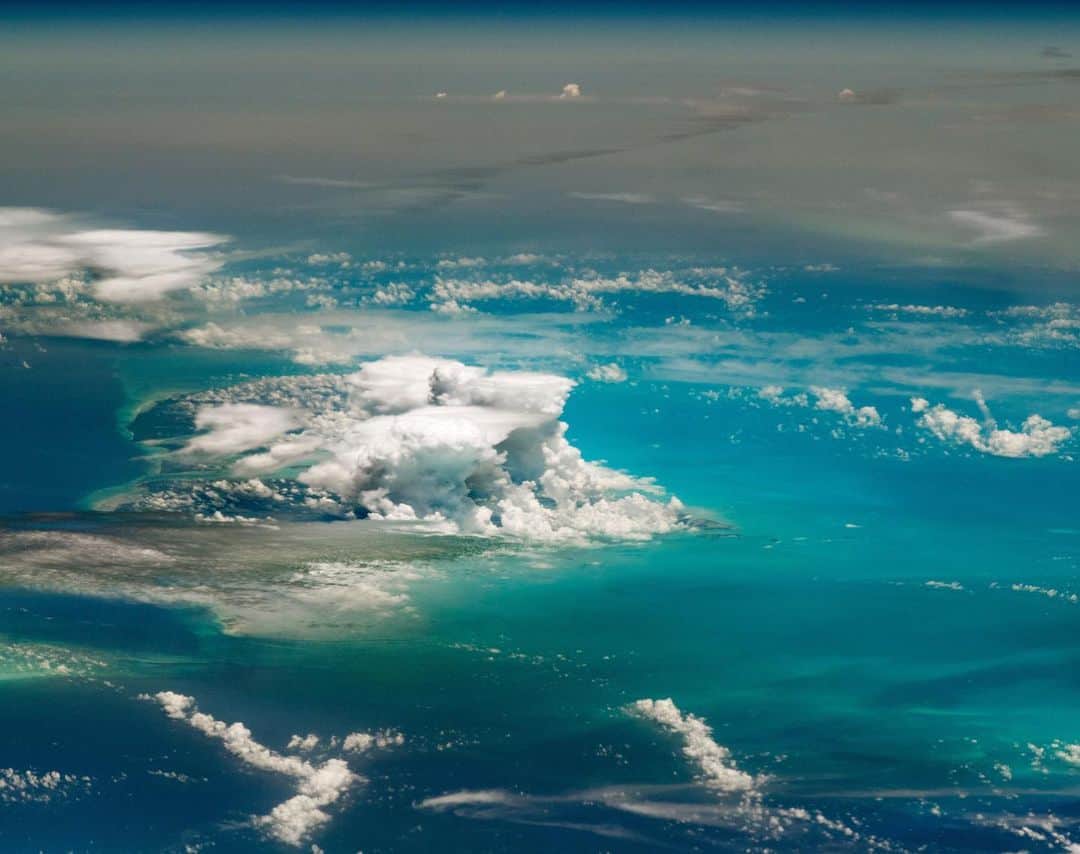 NASAさんのインスタグラム写真 - (NASAInstagram)「zoom... zoom... *click* 📸  There's more than meets the eye to this photo of storm clouds over the Bahamas. Although the @iss was passing over southern Indiana (nearly 1800 kilometers/1100 miles north) at the time of the photo, the crew managed to shoot what seems like a close-up view of Andros Island using a long lens camera. They caught thunderstorms rolling over the island and a striking view of the shallow sea floor known as the Great Bahama Bank.  Beyond the towering storms, the dull gray-brown pall of a dust plume is draped across the Caribbean Sea and Atlantic Ocean. The haze is so dense that it completely obscures the island of Cuba from the astronaut’s view.  It's all about perspective 😉  Credit: NASA  #Space #IslandLife #Bahamas #StormClouds」11月24日 3時46分 - nasa