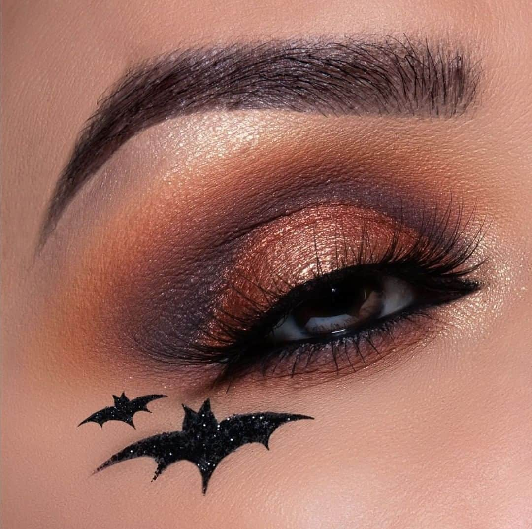 Motives Cosmeticsさんのインスタグラム写真 - (Motives CosmeticsInstagram)「Happy Halloween loves!  If you need us, we will be re-creating this eye look from @ElyMarino & snacking on candy + binge-watching spooky movies all day.  Get the look: 1.Taking “Heat Wave” blend slightly above the crease  2.Using “Dreamer” (Gold Digger Palette) blend into the crease and slightly above  3.Taking “Boudoir” blend into the crease and blend  4.Deepen the crease slightly by applying “Onyx” shadow  5.Pat “Mystical” onto the entire lid (Visionaire Palette)  6.Line the lower water line using “LBD” gel liner and blend out using “Boudoir, Dreamer & Heat Wave” 7.Highlight the center of the lid, inner corner of the eye and brow bone using “ Slay & Winning” (Gold Digger Palette)  8.For a fun touch draw a bat shape silhouette and fill in using “LBD” gel liner! Top off with Motives Glitter in “Ignite”. . .  . . . #motivescosmetics #motives #makeup #beauty #makeupartist #mua #everydaymakeup #naturalmakeup  #makeuptutorial #skincare #makeuplover #makeupaddict #beautywithbenefits  #halloweenmakeup #gtl #getthelook #eyemakeup」11月1日 5時00分 - motivescosmetics