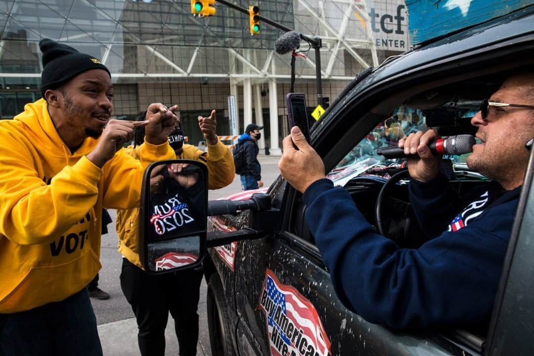 のインスタグラム：「Photo by David Guttenfelder @dguttenfelder / Ralph Gaines and Angelo Austin argue with a Trump supporter protesting the validity of the presidential vote count outside the TCF Center, where votes are being tallied, in Detroit, Michigan.  Austin said, "My ancestors helped to build this city. These people think I'm wrong for not wanting to support the president who is a racist and a sexist. They are out here without a mask and not social distancing because they don't care about anyone but themselves."  "The votes were counted," Gaines added. "We should all be coming together right now. We need a president who leads and who takes care of everybody. He's just causing chaos."」