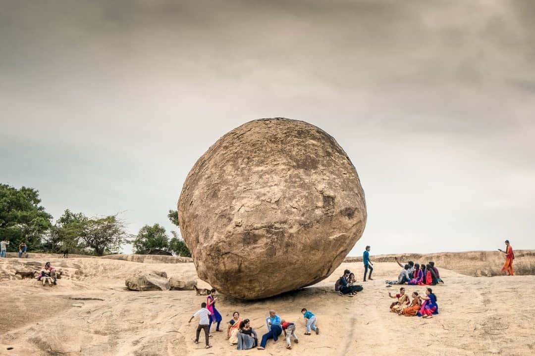 National Geographic Travelさんのインスタグラム写真 - (National Geographic TravelInstagram)「Photo by @francescolastrucci / Visitors hang out around Krishna's Butterball, a massive granite boulder perfectly balanced on a slippery slope in historical Mahabalipuram, in the Tamil Nadu state of India. Estimated to weigh over 250 tons, this mysterious monolith raises many unanswered questions. Though it was originally known as Vaanirai Kal, meaning in Tamil "stone of the sky god," it is now known as Krishna’s Butterball. This comes from a myth telling that butter was Krishna’s favorite food and that he would often sneak a bolus of butter from his mother’s jar. The giant boulder, which appears to be frozen mid-roll, is believed to be naturally formed, but theorists debate how corrosion could have given the rock such a shape.  Follow me @francescolastrucci for more places, daily life, and stories around the world. #india #balance #dailylife」11月6日 12時35分 - natgeotravel