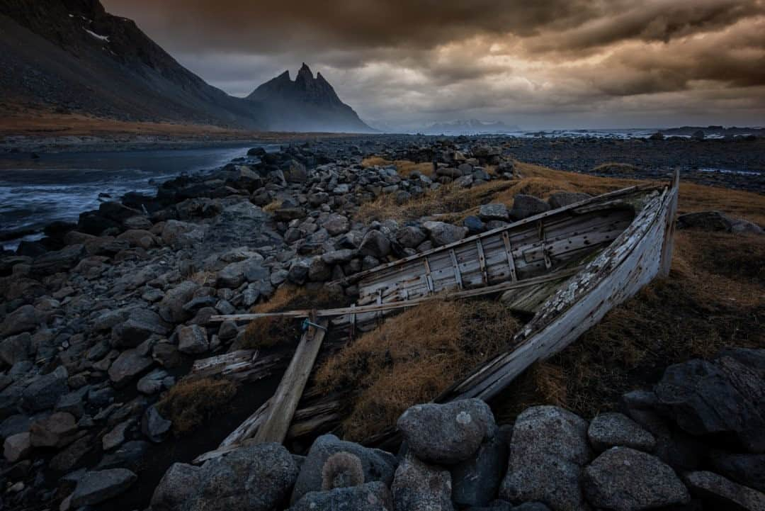 National Geographic Travelさんのインスタグラム写真 - (National Geographic TravelInstagram)「Photo by Keith Ladzinski @ladzinski / On the southeast coast of Iceland an old, abandoned boat sits marooned under stormy skies at the foot of the Stokksnes/Vestrahorn mountains. #Stokksnes #Vestrahorn」11月7日 8時35分 - natgeotravel