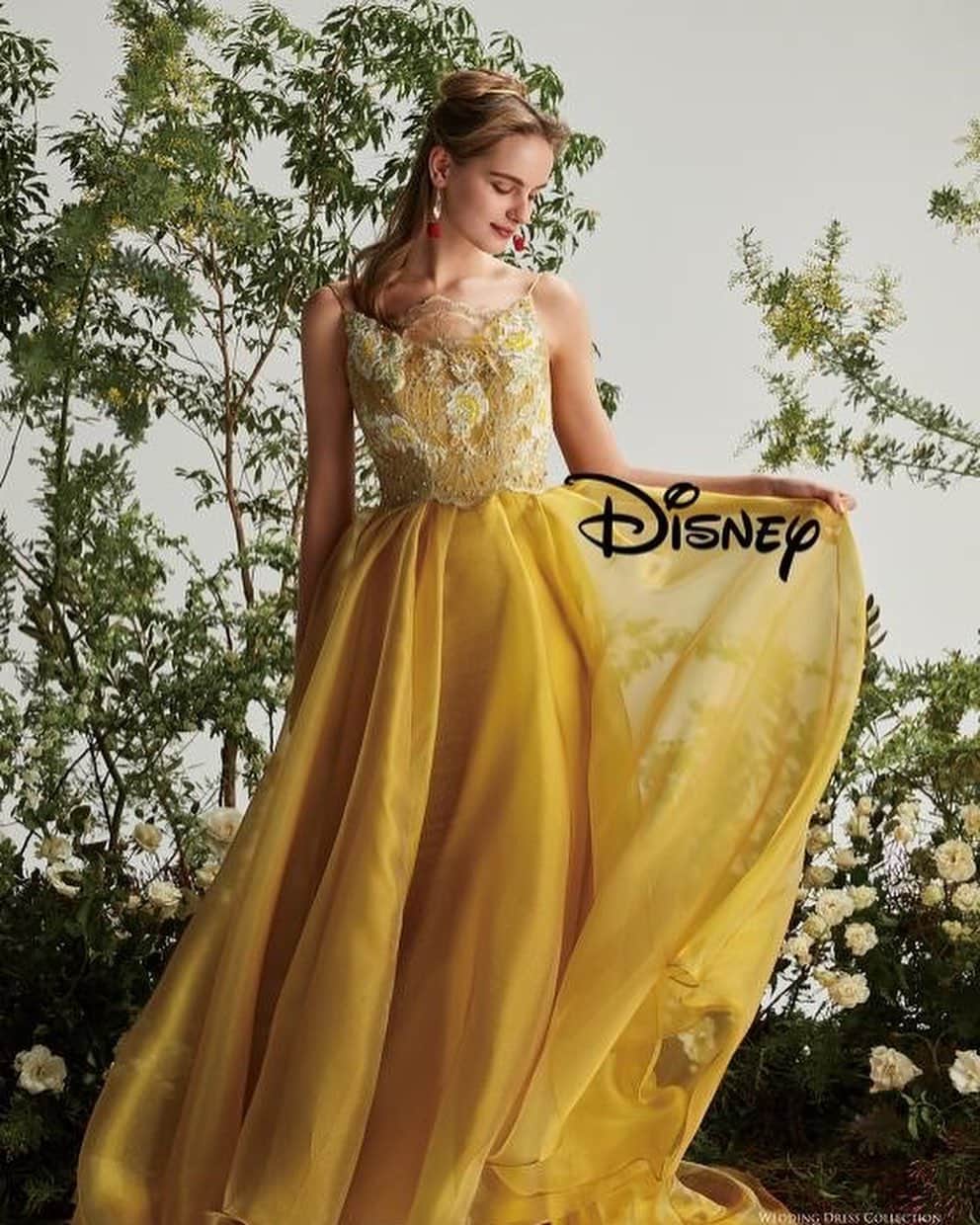 St.AQUA 東京の結婚式場 サンアクアチャペルのインスタグラム：「●DWS1005（yellow） 『美女と野獣』のベルからインスパイアされたドレス。光沢があり、肌ざわりの良いサテンオーガンを使用し、胸元には2種類のバラモチーフを施したリバーレースが印象的な高級感のあるドレスです。  #disney #disneyprincess #princess #disney_weddingdresscollection #wedding #weddingdress #dress #bridal #colordress #ディズニー #ディズニー_ウエディングドレス コレクション #ディズニープリンセス #プリンセス #ウェディングドレス #カラードレス ?#結婚式 #結婚 #プレ花嫁 ?#卒花嫁 #花嫁 #ベル #イエロードレス #クラウディア #kuraudia ?ディズニーオフィシャルホテルへの持ち込みは ご遠慮いただいております。 ©Disney」