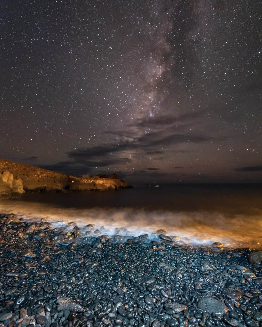National Geographic Travelさんのインスタグラム写真 - (National Geographic TravelInstagram)「Photo by @babaktafreshi / The summer Milky Way appears above a beach and a village in La Palma, Canary Islands. Our world looks infinite from the surface with vast oceans, lands, and life, horizon after horizon. But from space it's just one limited sphere that cannot feed almost eight billion people, unless we stop our throwaway lifestyle. Explore more of the world at night photography @babaktafreshi. #earth #stopthewaste #twanight #ocean」11月7日 16時39分 - natgeotravel