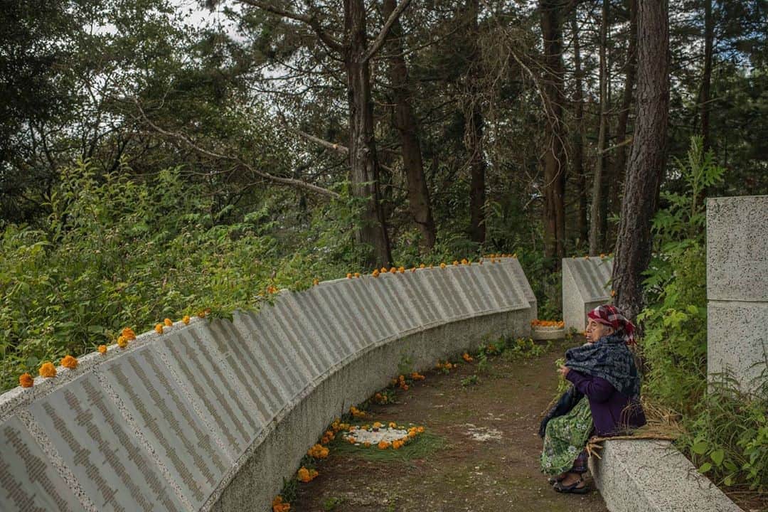National Geographic Creativeさんのインスタグラム写真 - (National Geographic CreativeInstagram)「Photo by @daniele_volpe / Teodora Velasquez, 86, visits "Paisajes de la Memoria" (Memory Landscapes) during the Day of the Dead celebrations, in a plot of land where there was an army camp during the Guatemalan Civil War and where forensic anthropologists found 220 human remains. Now the place serves as a memorial to honor the victims of state repression. During the Civil War, Teodora's husband, was kidnapped by the Guatemalan Army in 1982.  In Guatemala, and in other countries of the region, the "Day of the Dead" celebrations are deeply felt. The tradition consists of visiting the tombs of loved ones during November 1 and 2. Generally, families bring food and drinks as a way to "share" that with the relatives that died. The tradition is a happy occasion, accompanied by music and surrounded by food street vendors. This year, due to COVID-19, Guatemalan authorities decided to restrict access to the cemeteries to avoid crowds.  After the 36-year-long Guatemalan Civil War (1960-96), according to the UN, Guatemala counts more than 200,000 victims and 45,000 missing people including civilians. After the peace accords, human rights organizations started an effort to find the remains of the "desaparecidos." Chimaltenango was one of the departments of the country hardest hit by the state repression and has well-known atrocities that happened in San Juan Comalapa.  In 2003, forensic anthropologists started digging in a plot of land where an army camp once stood. They found the remains of 220 people in several mass graves. People that were kidnapped by the Guatemalan Army, executed and buried inside that army camp. After DNA analysis, 172 of them are still unidentified.  Taken on assignment for @natgeo and @icrc.」11月7日 22時31分 - natgeointhefield