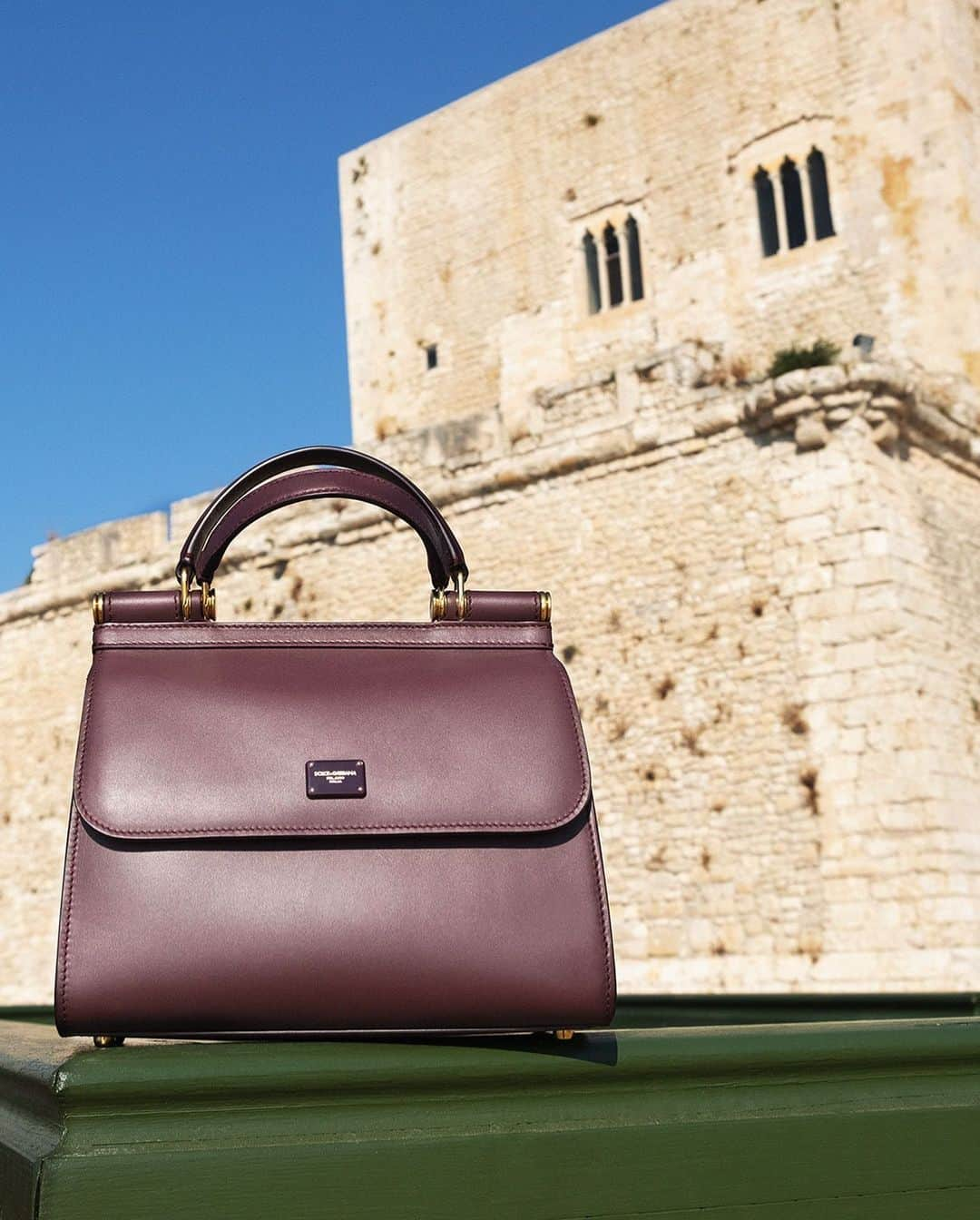 ドルチェ&ガッバーナさんのインスタグラム写真 - (ドルチェ&ガッバーナInstagram)「⁣⁣⁣⁣The medium-sized burgundy #DGSicily58 Bag is presented in front of the Torre Cabrera, a watchtower in Pozzallo dating back to the 15th century.⠀ ⠀ Continue the tour of Sicily and discover more variations of the iconic #DGSicilyBag at the link in bio.⠀ ⠀ #DGFattoAMano #DGDNA #MadeInItaly #DolceGabbana⠀」11月9日 5時00分 - dolcegabbana