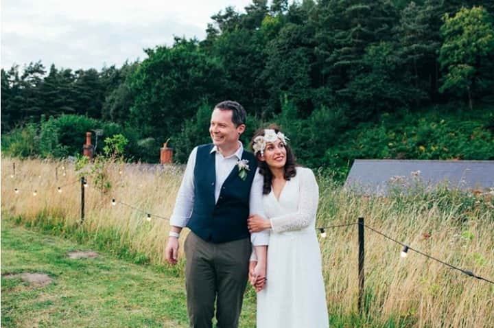 ミナのインスタグラム：「Going through archives and bumped into this wonderful festival inspired wedding that was featured on @whimsicalwonderlandweddings. Lynne and Bruce got married at @thekeeperandthedell and their fun outdoors wedding featured tipis, marquee, rustic furniture, hay bales, bonfire, bunting, rugs, face painting etc. Everything you need to create a relaxed and fun celebration with your friends and family. Lynne was wearing our comfy Janine dress and the accessories were made for her. Link in bio.⁠ ⁠ Photography: @emilytylerphoto⁠ ⁠」