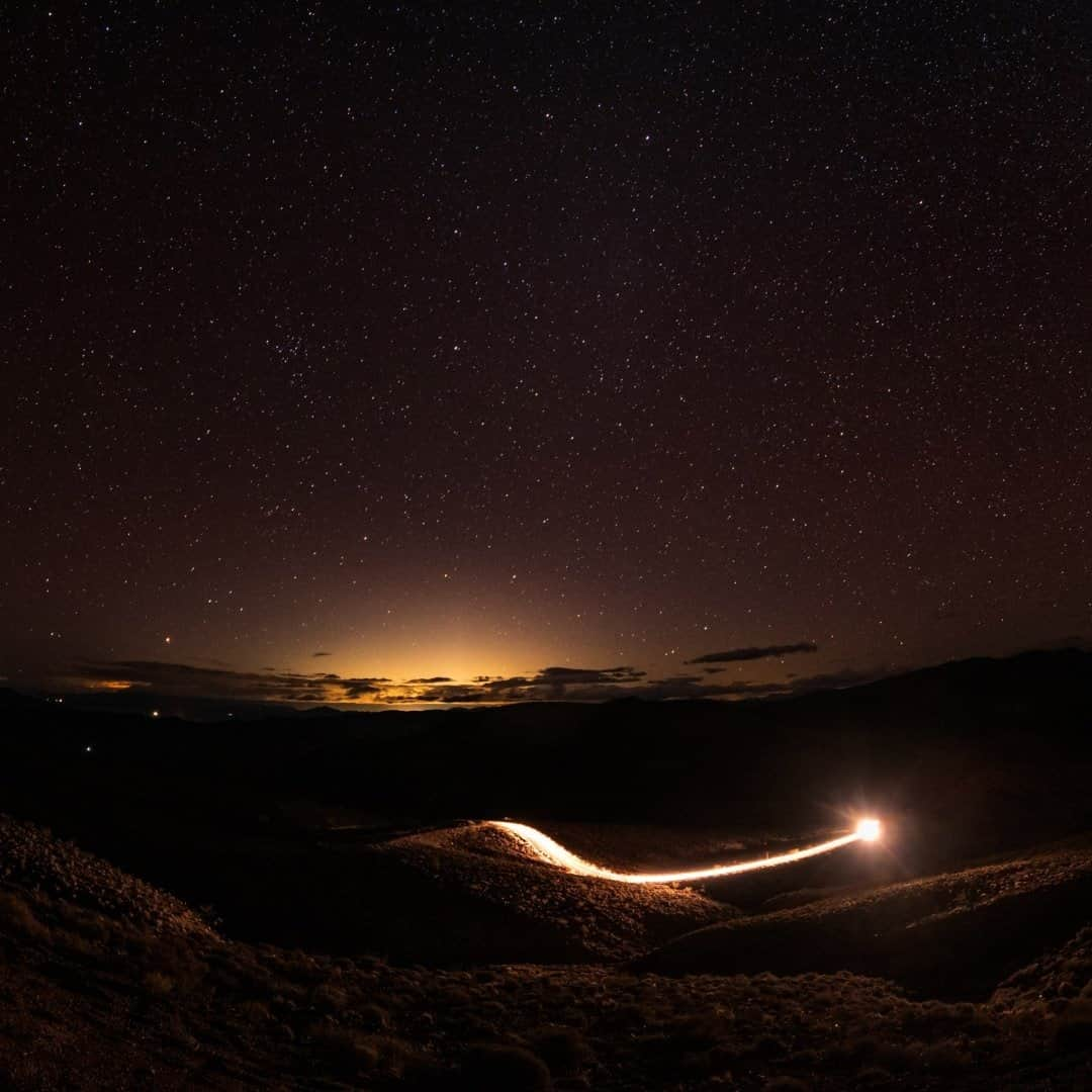 National Geographic Travelさんのインスタグラム写真 - (National Geographic TravelInstagram)「Photo by @babaktafreshi / During a pitch-black, starry night in Death Valley National Park, a car drives downhill from a mountain vista looking toward the east. The yellow glow on the horizon resembles sunrise, but it is actually Las Vegas at midnight, from 90 miles (145 kilometers) away!  ⁣⁣Inside cities with so much light, you are enveloped in the artificial skyglow where the natural night environment is gone. According to the International Dark Sky Association, the negative effects of this loss might seem intangible, but a growing body of evidence links the brightening night sky to increasing energy consumption,⁣ disrupting the ecosystem and wildlife,⁣ harming human health⁣, and effecting crime and safety negatively. ⁣The good news is that light pollution, unlike many other forms of pollution, is reversible, and each one of us can make a difference by learning more.  Look for "Our Nights Are Getting Brighter" on natgeo.com and explore more with me @babaktafreshi. ⁣#lightpollution #saveournightsky #lasvegas @deathvalleynps @idadarksky」11月13日 8時36分 - natgeotravel