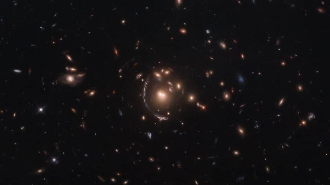 NASAさんのインスタグラム写真 - (NASAInstagram)「This @nasahubble image features the galaxy LRG-3-817, also known as SDSS J090122.37+181432.3. The galaxy, its image distorted by the effects of gravitational lensing, appears as a long arc to the left of the central galaxy cluster.  Gravitational lensing occurs when a large distribution of matter, such as a galaxy cluster, sits between Earth and a distant light source. As space is warped by massive objects, the light from the distant object bends as it travels to us and we see a distorted image of it. This effect was first predicted by Einstein’s general theory of relativity.  Strong gravitational lenses provide an opportunity for studying properties of distant galaxies, since Hubble can resolve details within the multiple arcs that are one of the main results of gravitational lensing. An important consequence of lensing distortion is magnification, allowing us to observe objects that would otherwise be too far away and too faint to be seen. Hubble makes use of this magnification effect to study objects beyond those normally detectable with the sensitivity of its 2.4-meter-diameter primary mirror, showing us the most distant galaxies humanity has ever encountered.  Credit: ESA/Hubble & NASA, S. Allam et al.」11月15日 0時07分 - nasagoddard