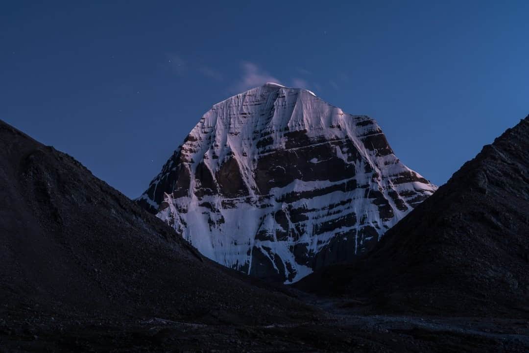National Geographic Travelさんのインスタグラム写真 - (National Geographic TravelInstagram)「Photo by Brendan Hoffman @hoffmanbrendan / The north face of Mount Kailash, in far western Tibet, is seen at dusk. Also known as Kangrinboqe, the peak is sacred to four religions. Hindus, Buddhists, Jains, and Bönpo all make high-altitude pilgrimages in a circle around its base on a trail of some 53 kilometers (33 miles). However, the mountain itself, topping out at 6,638 meters (21,778 feet), has never been climbed.  Follow me @hoffmanbrendan for more stories from around the world. #mountkailash #tibet #china」11月14日 20時39分 - natgeotravel