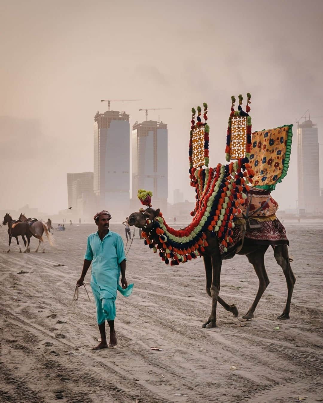 National Geographic Travelさんのインスタグラム写真 - (National Geographic TravelInstagram)「Photo by @junmichaelpark / A Pakistani oont walah, or camel guy in Urdu, walks on Clifton Beach looking for customers in Karachi, Pakistan. My guide Uzair eloquently described the state of Pakistan as "ordered chaos." Perhaps this photo provides a glimpse into the beautiful, but often troubled and misunderstood, country. For more photos and stories, follow @junmichaelpark.」11月15日 4時36分 - natgeotravel