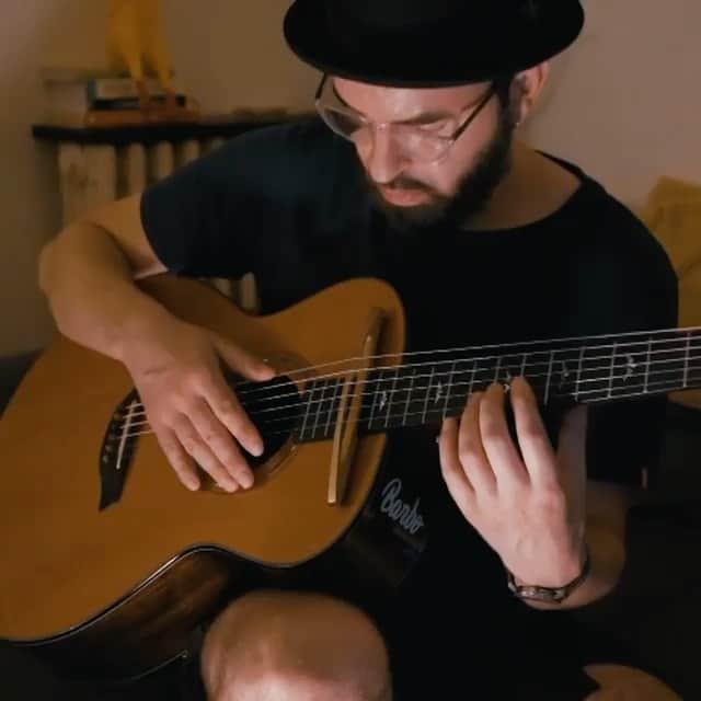 カーキ・キングのインスタグラム：「Today's passerelle model is the bearded and hatted @barbomusic and I absolutely love this take--holding the guitar as one normally does, strumming with some backbeat. Absolutely gorgeous. Pick up a passerelle today! Link to my webstore in my bio and use code Kaki20 for 20% off everything until Nov 30!   Repost from @barbomusic • Another try with the Passerelle Bridge ! Uncropped video on my YT channel ;) . . . . #fingerstyle #guitarist #fingerstylegram_ #fingerstyleguitar #acoustic #acousticguitar #candyrat #Guitarstagram #koto #guzhengplayer #guitarhacks #guitar_share #6stringsdaily #lickwars #guzheng #lickwars #pickariff #guitarstars #riffwars #solosection #percussiveguitar #talentedmusicians #guitartricks #highonguitar #fingerpicking」