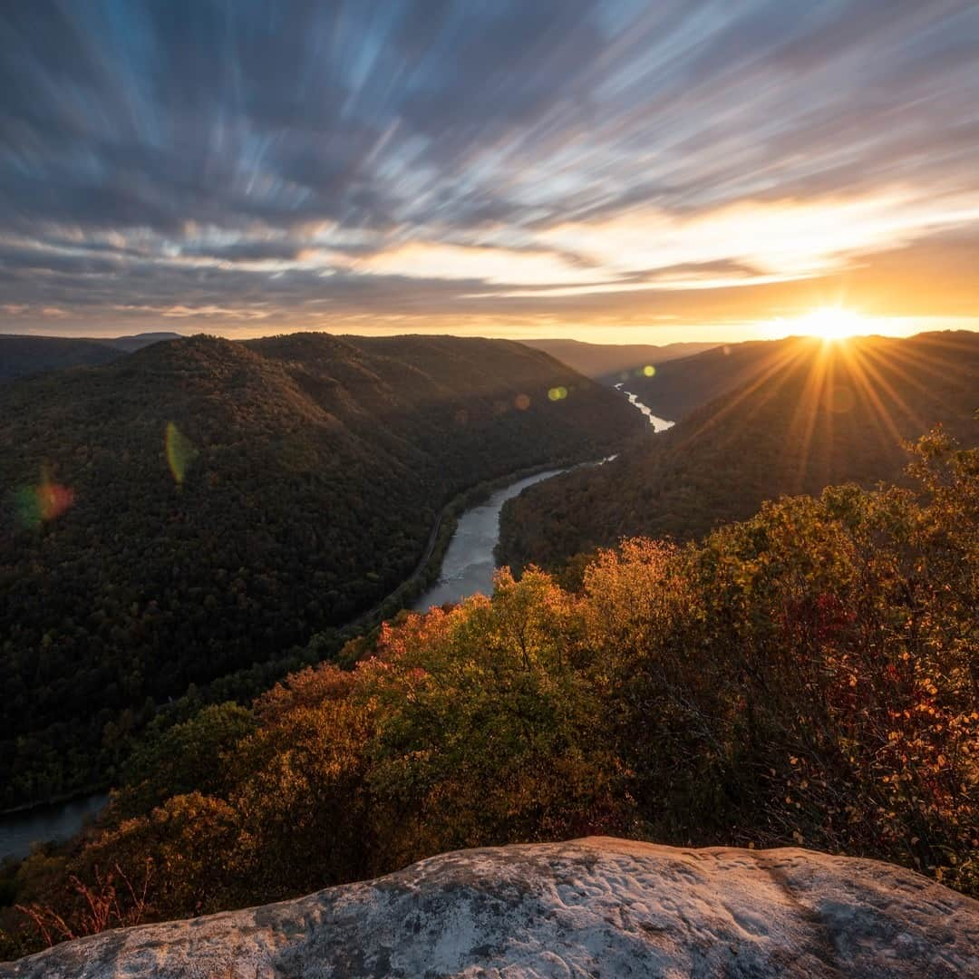 アメリカ内務省さんのインスタグラム写真 - (アメリカ内務省Instagram)「The New River is among the oldest rivers on the continent. A view from the upper reaches in #WestVirginia showcases the rugged whitewater flowing northward through deep canyons. When Nick Palastro took this shot, there was a brief moment of intense light illuminating the #autumn colors in the foreground and shining across the river, right before the sun rose behind the cloud deck racing overhead. The New River Gorge National River encompasses over 70,000 acres of land along the New River; it offers an abundance of #scenic and #recreational opportunities with a fascinating history. Photo courtesy of Nick Palastro (@nickpalastro). #usinterior #FindYourPark  #NewRiverGorgeNationalRiver」11月18日 10時12分 - usinterior